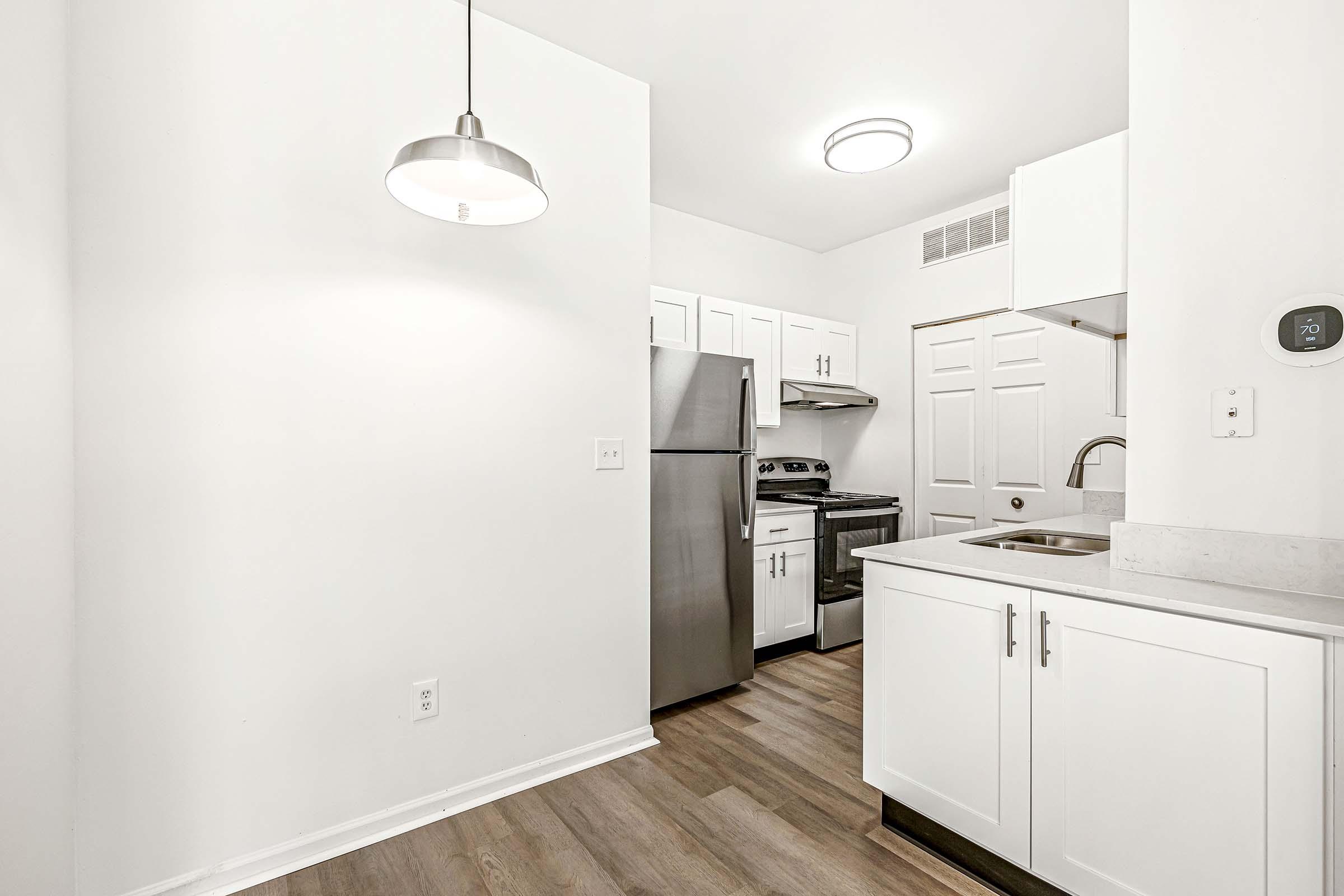 a kitchen with a sink and a refrigerator