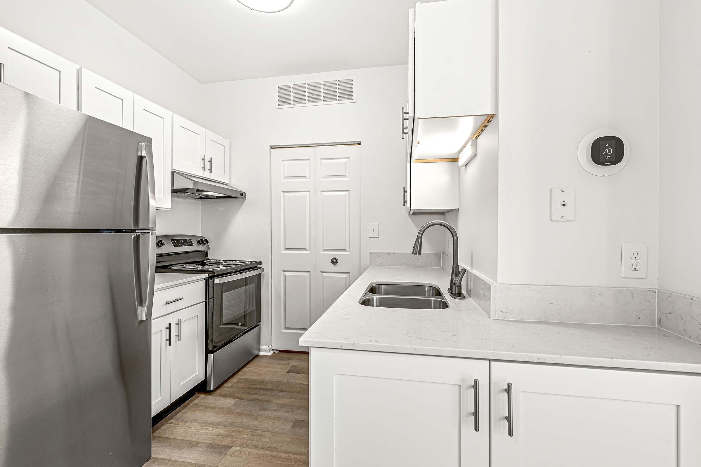 a kitchen with a sink and a refrigerator