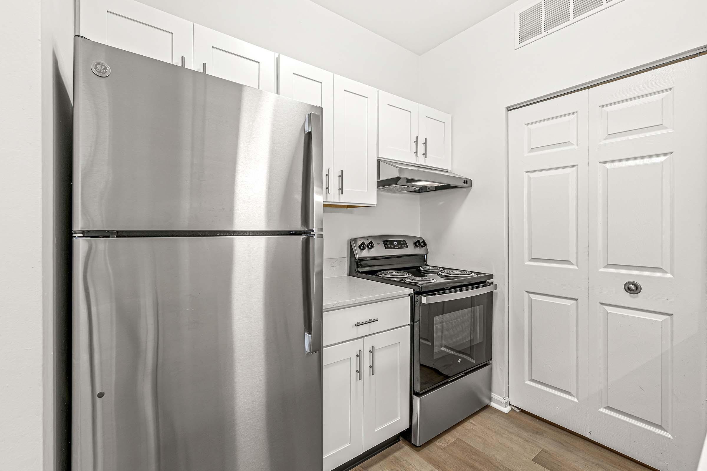 a refrigerator freezer sitting inside of a kitchen