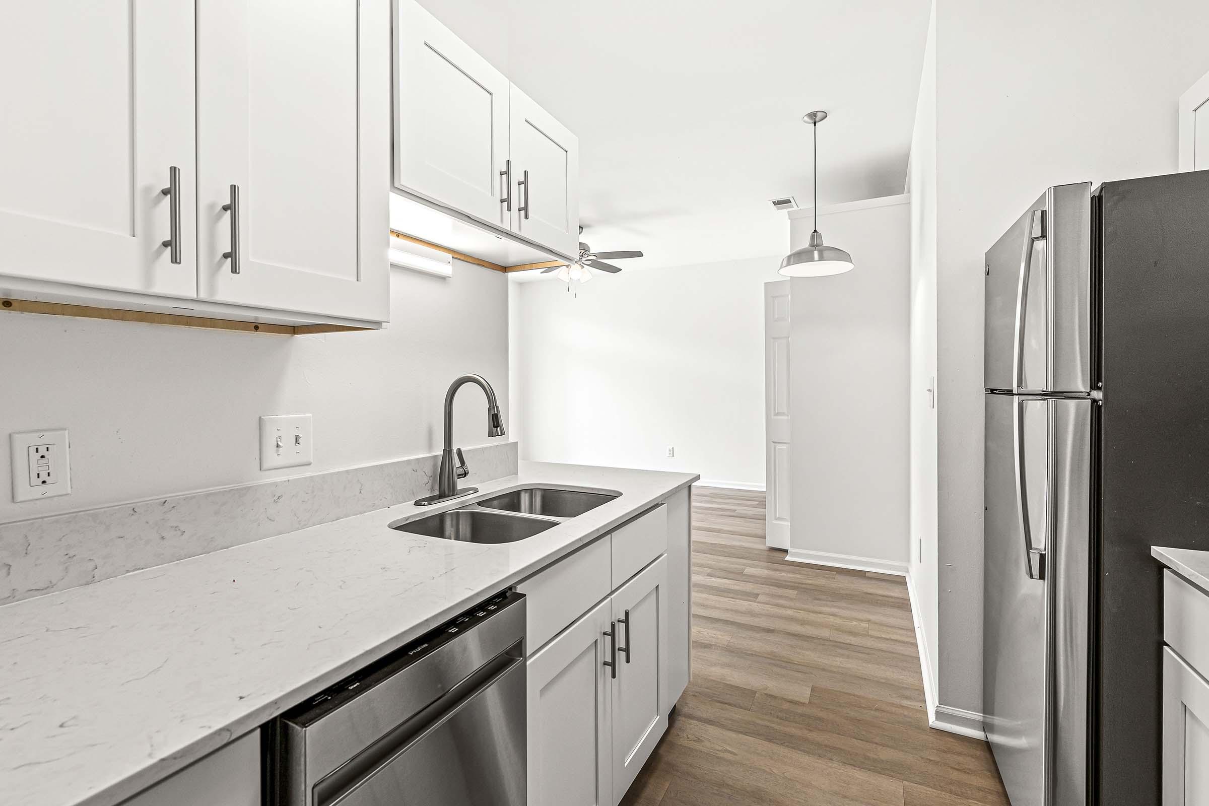 a kitchen with a sink and a refrigerator