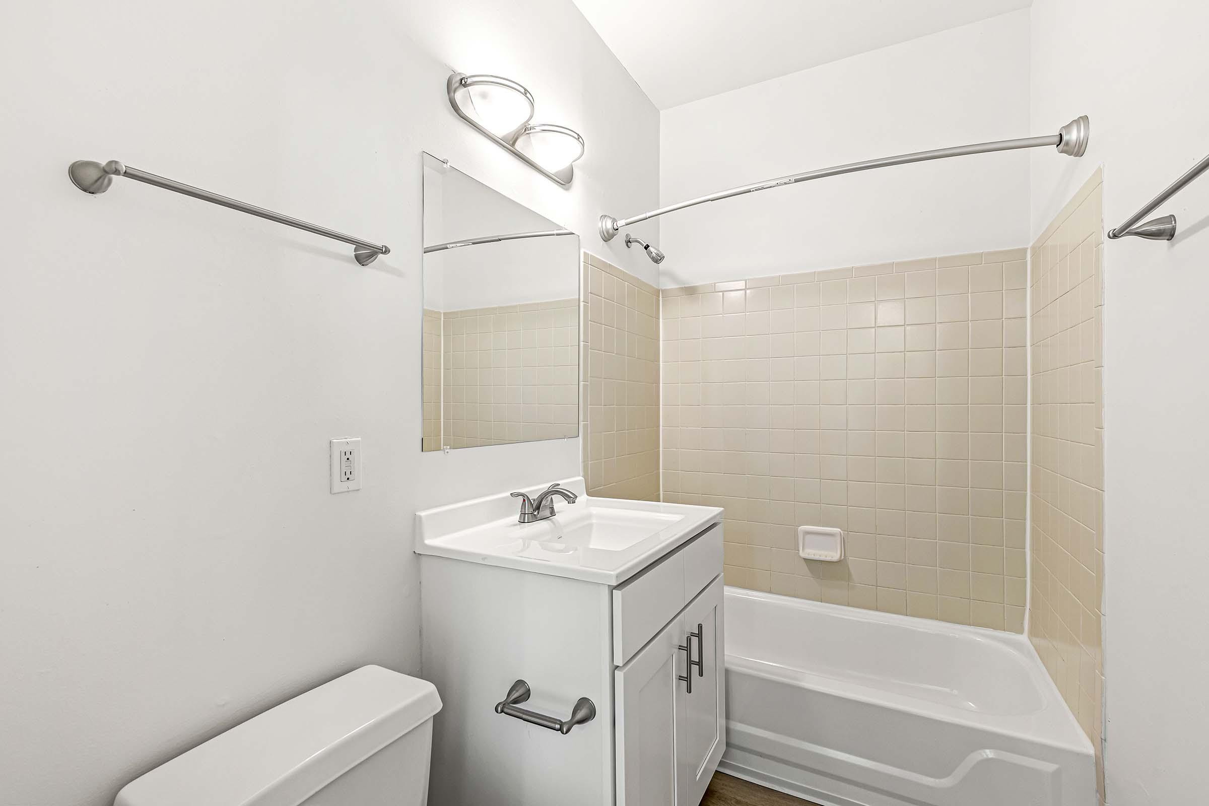 a sink sitting under a mirror