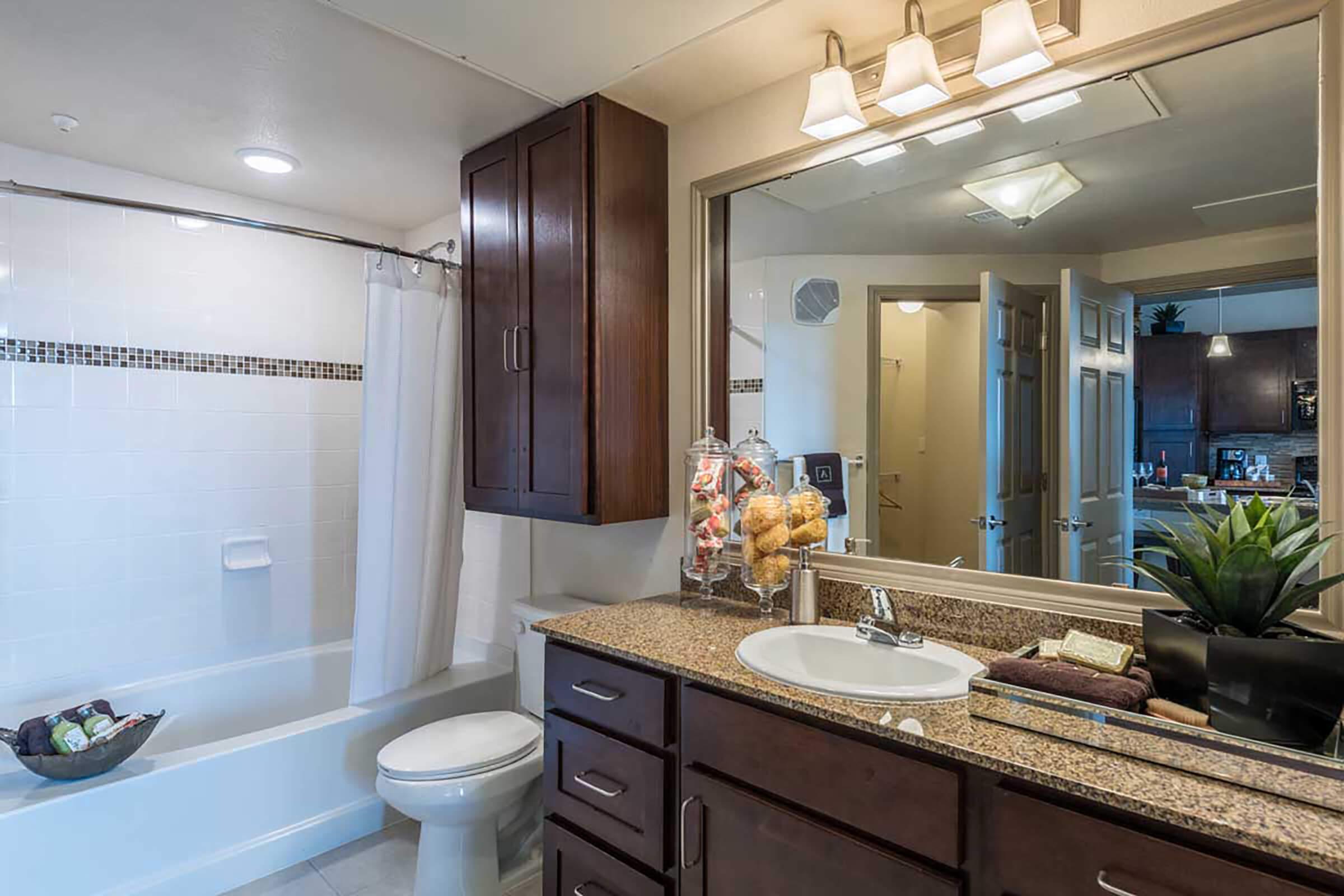 a kitchen with a sink and a mirror