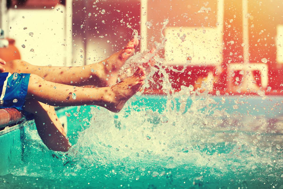 Boys legs splashing water in pool vintage iStock-647555920.jpg
