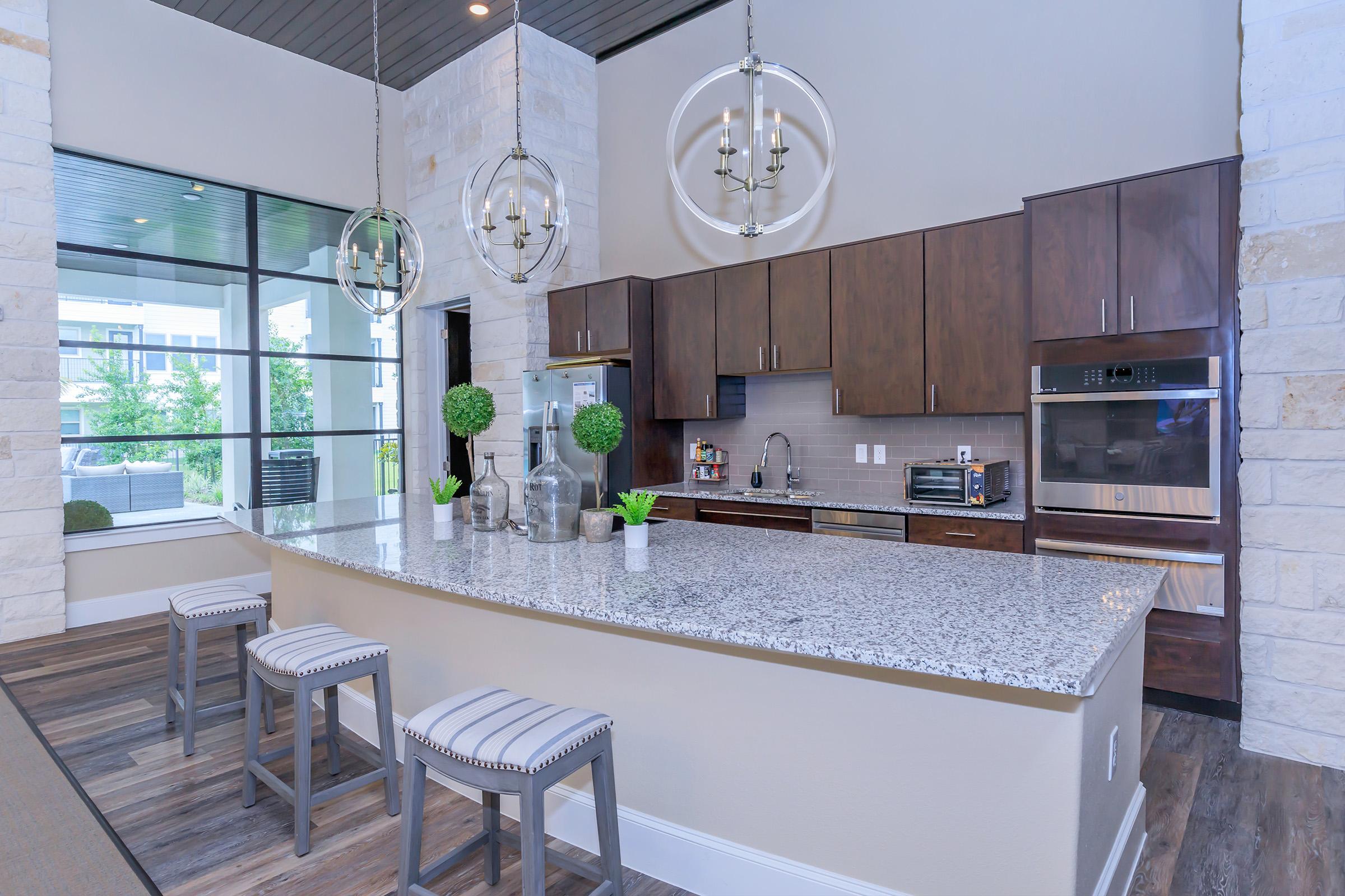 a kitchen area with a building in the background