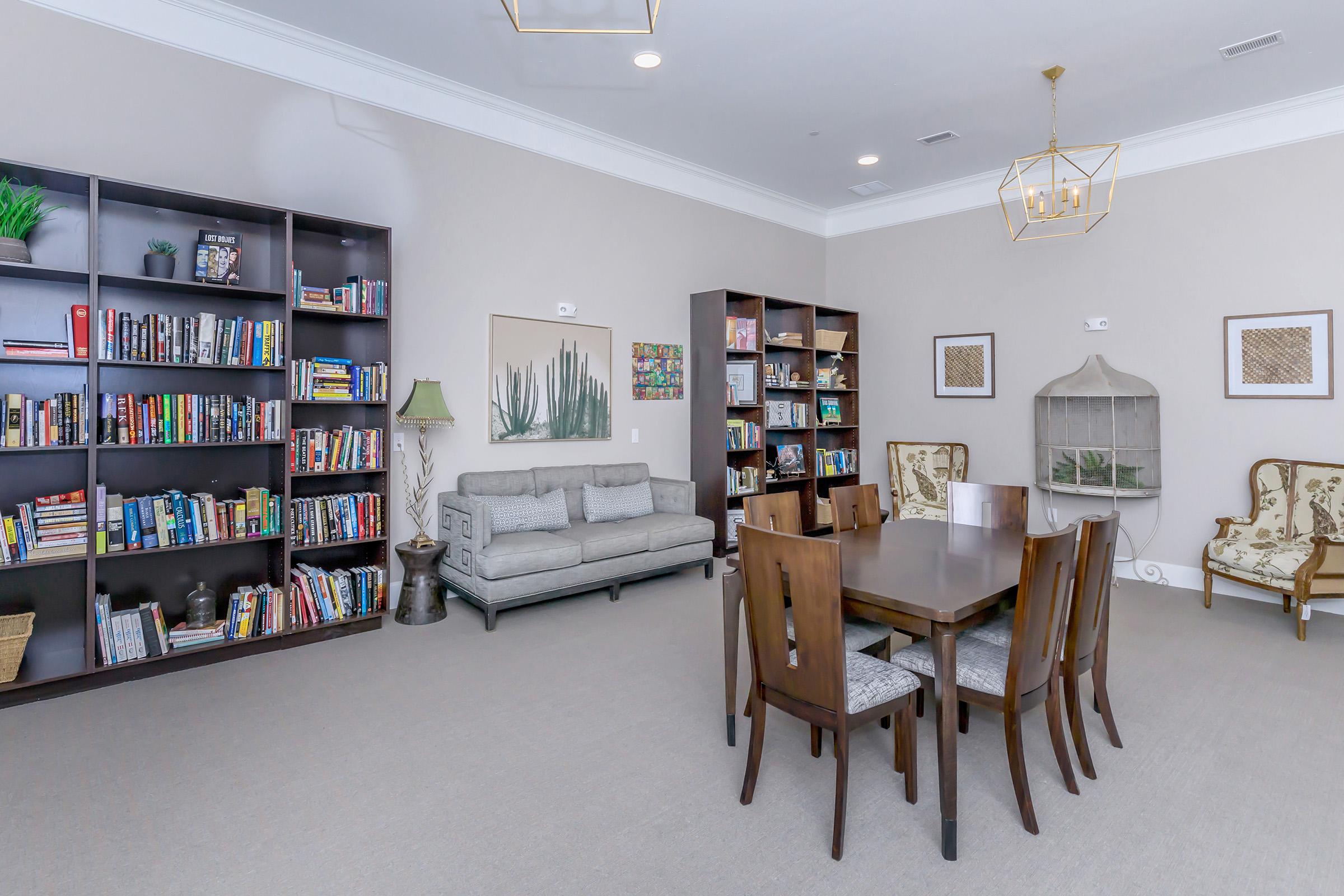 a living room filled with furniture and a book shelf