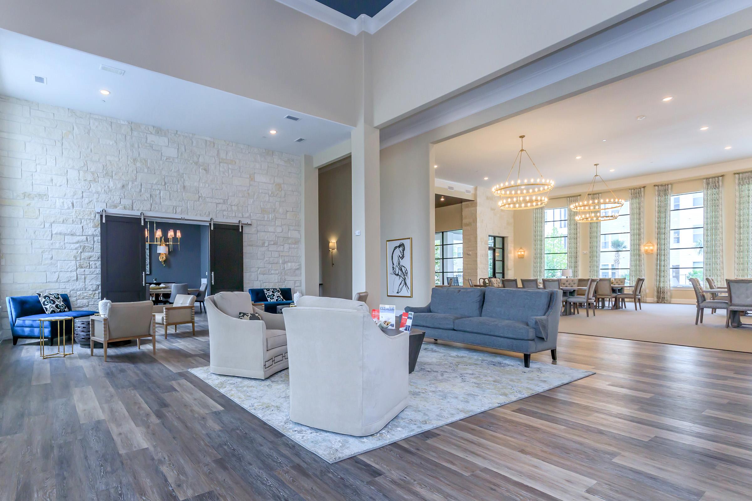 a living room filled with furniture and a large window