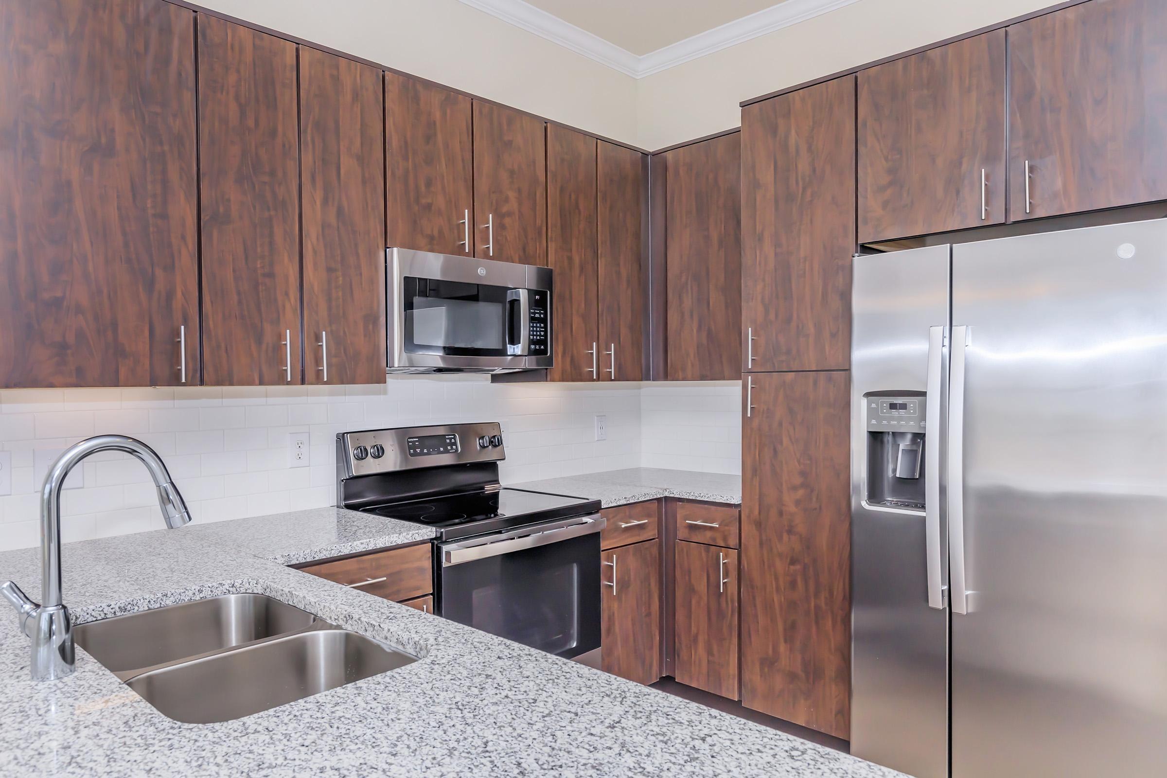 a kitchen with stainless steel appliances and wooden cabinets