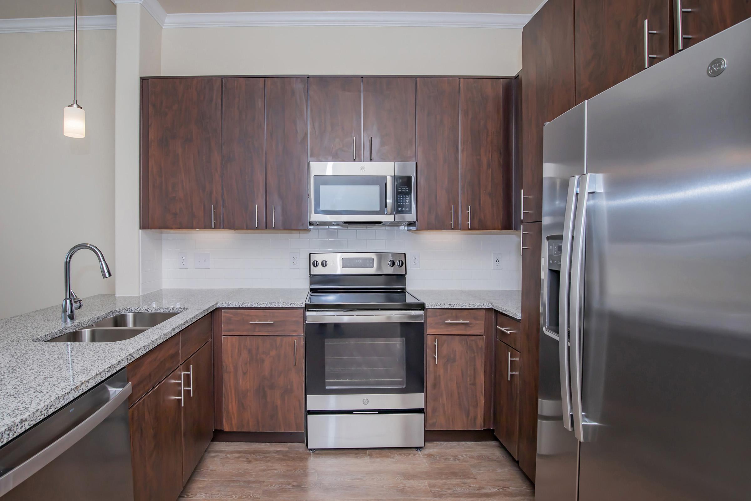 a kitchen with stainless steel appliances and wooden cabinets