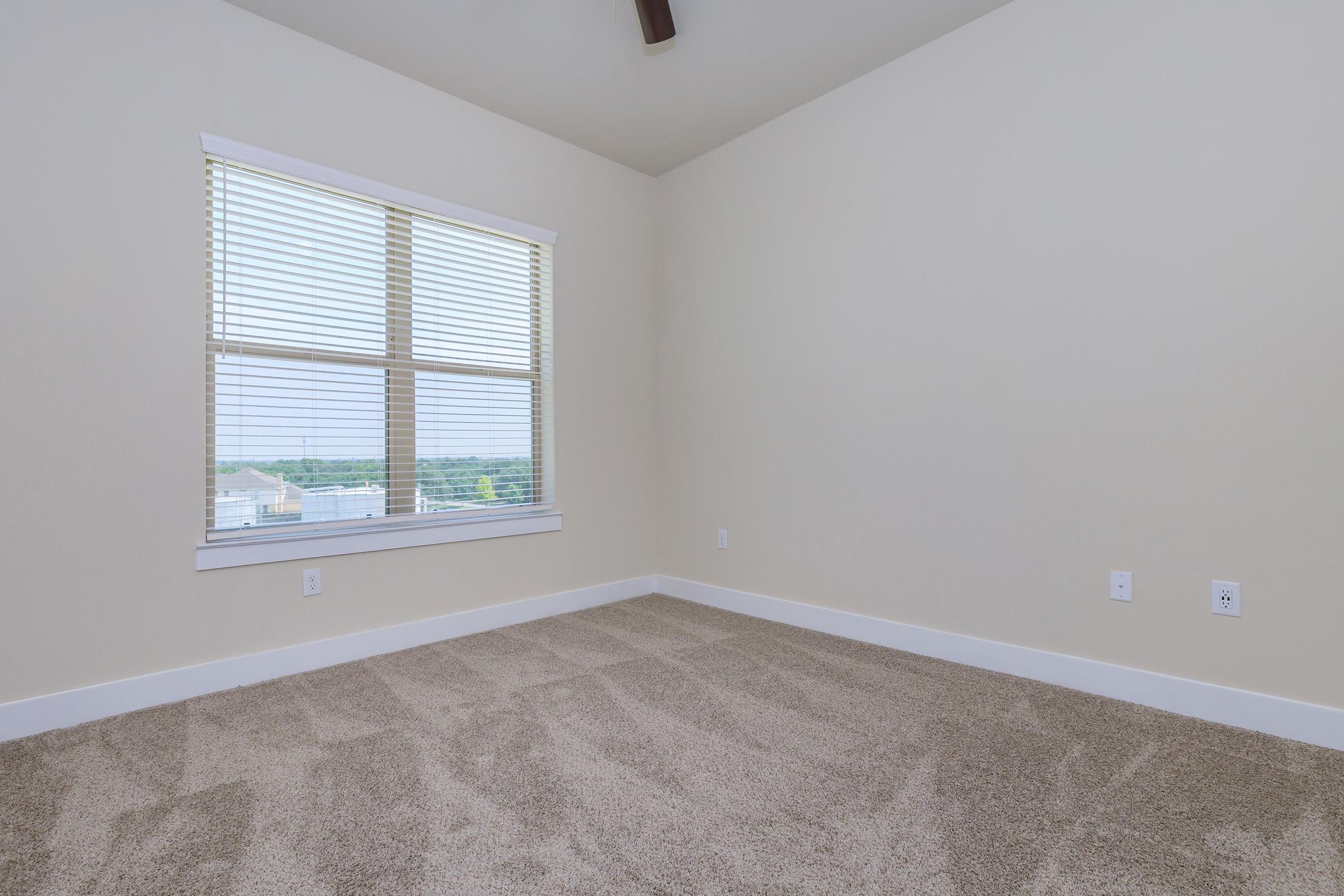 a bedroom with a large window