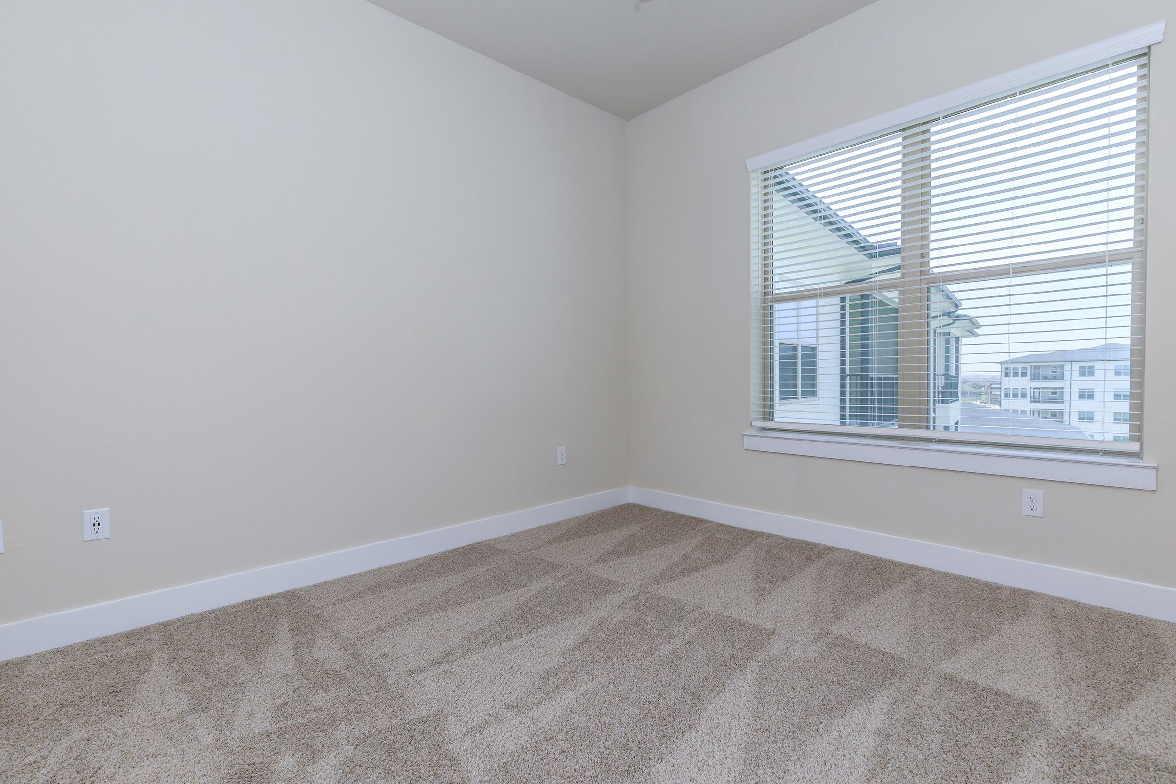 a bedroom with a large window