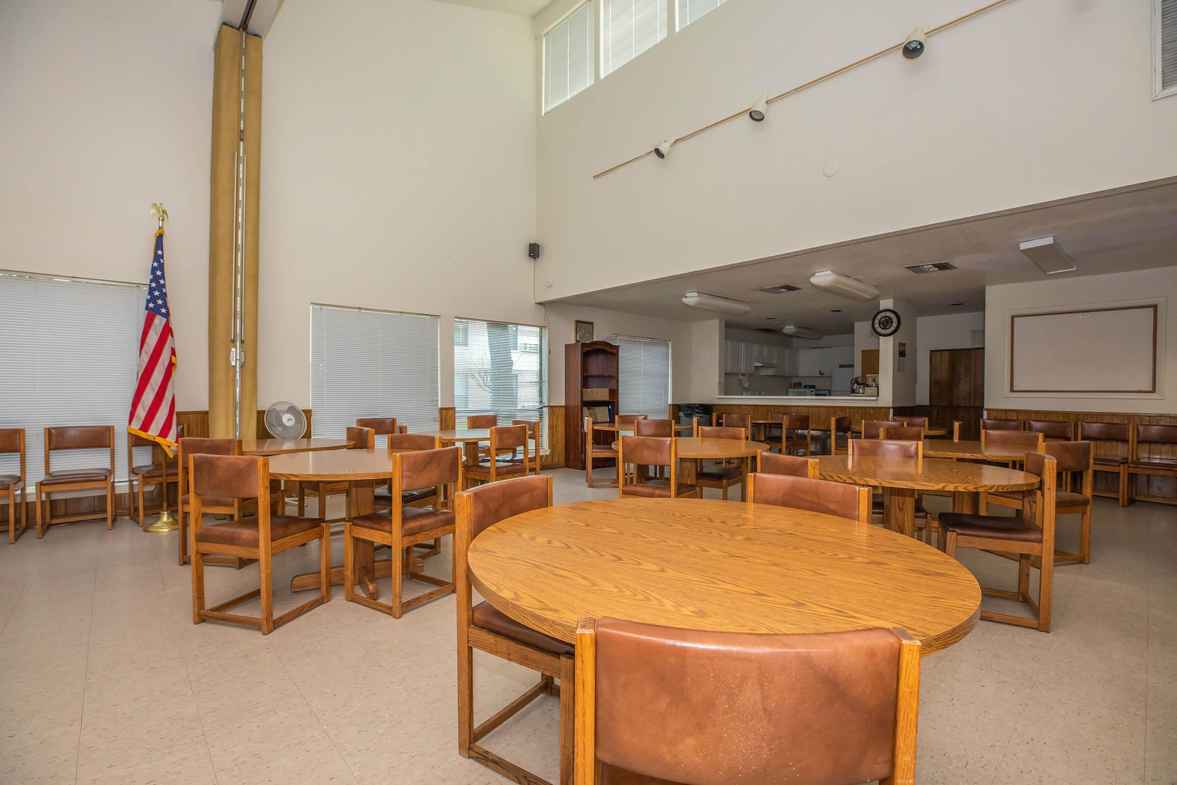 Pineview at Grogansmill community room with tables and chairs