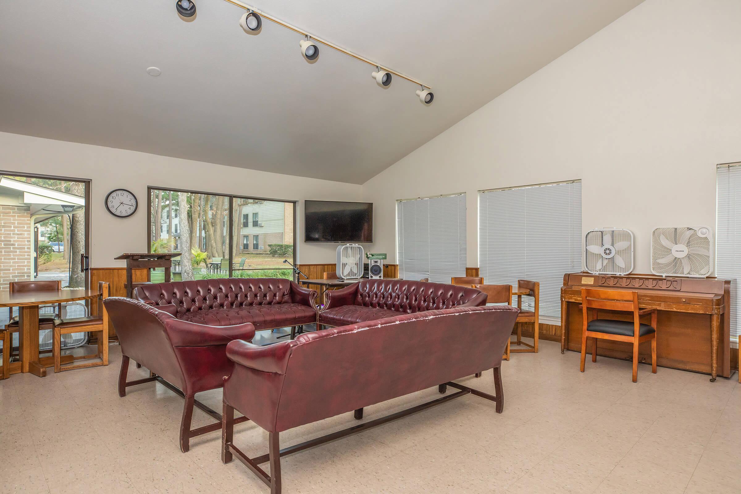 Community room with brown couches