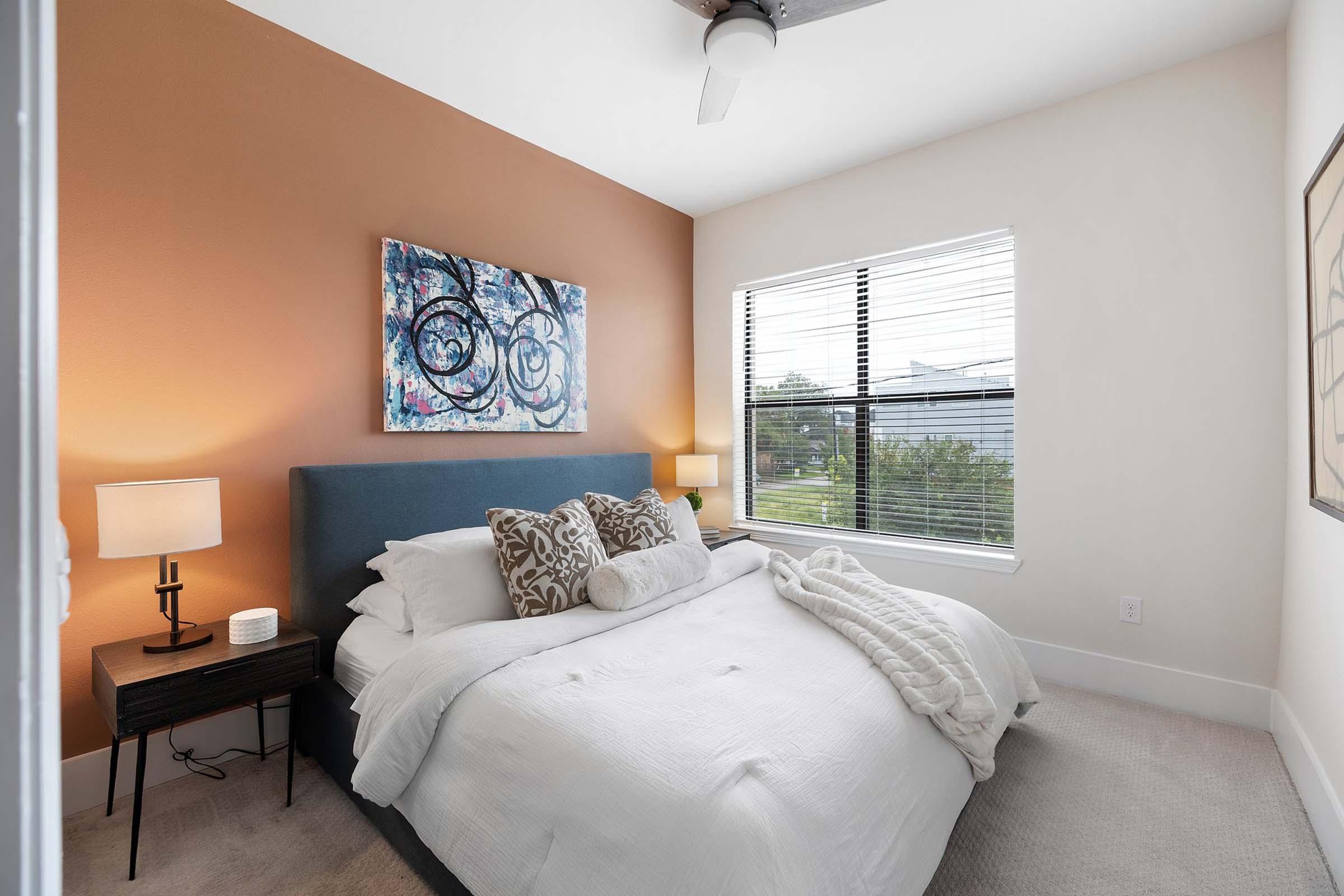 a bedroom with a view of a living room