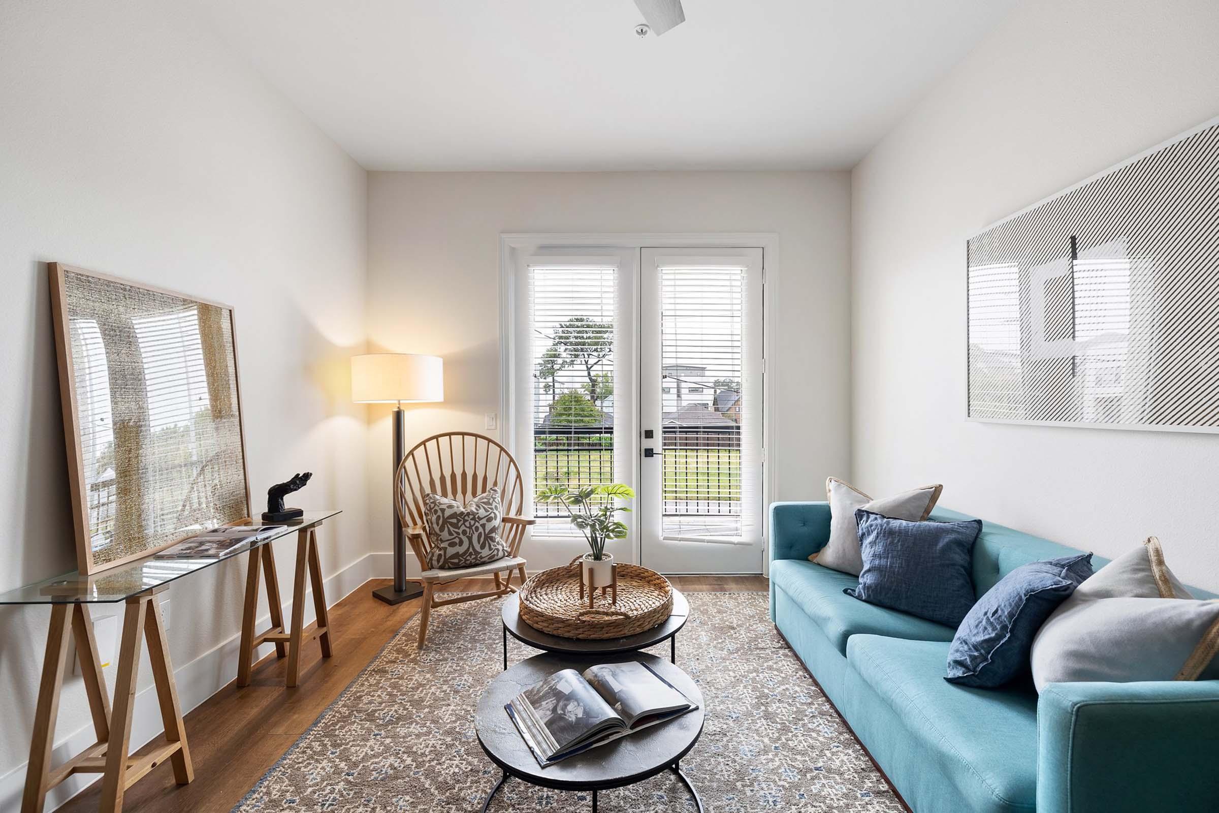 a living room filled with furniture and a large window