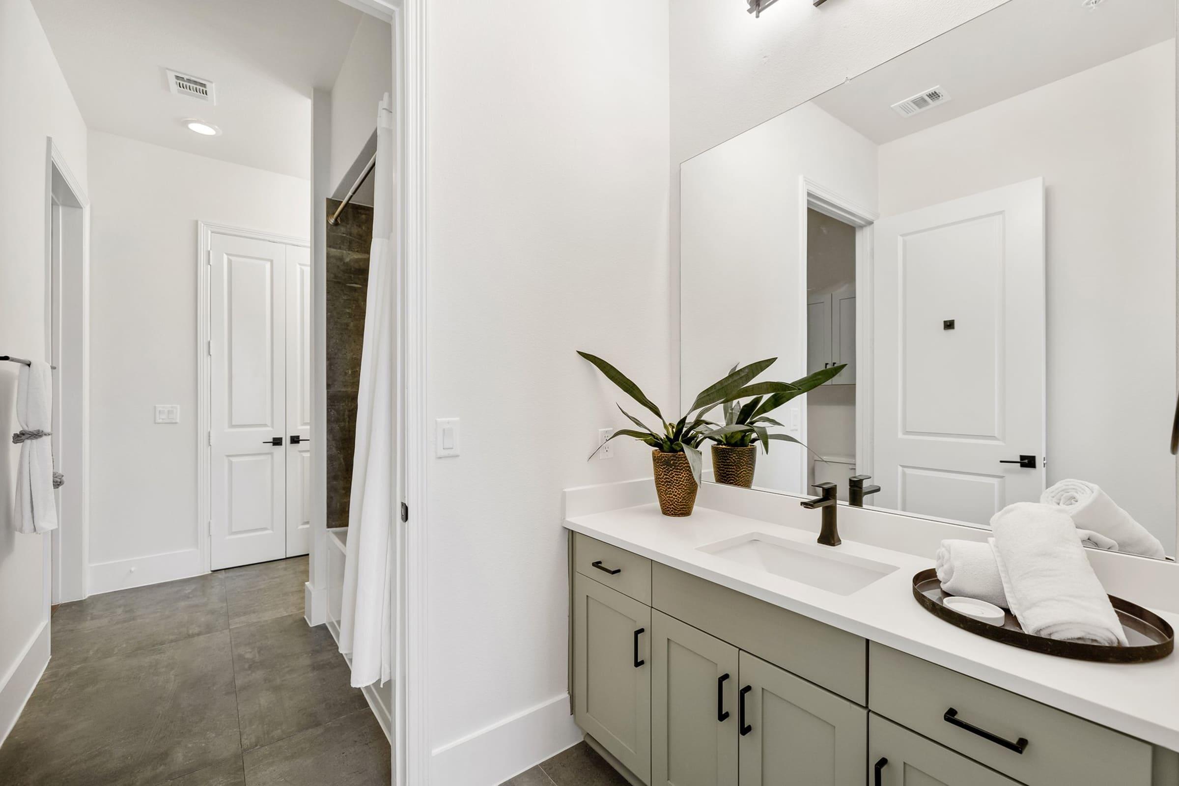 a kitchen with a sink and a mirror