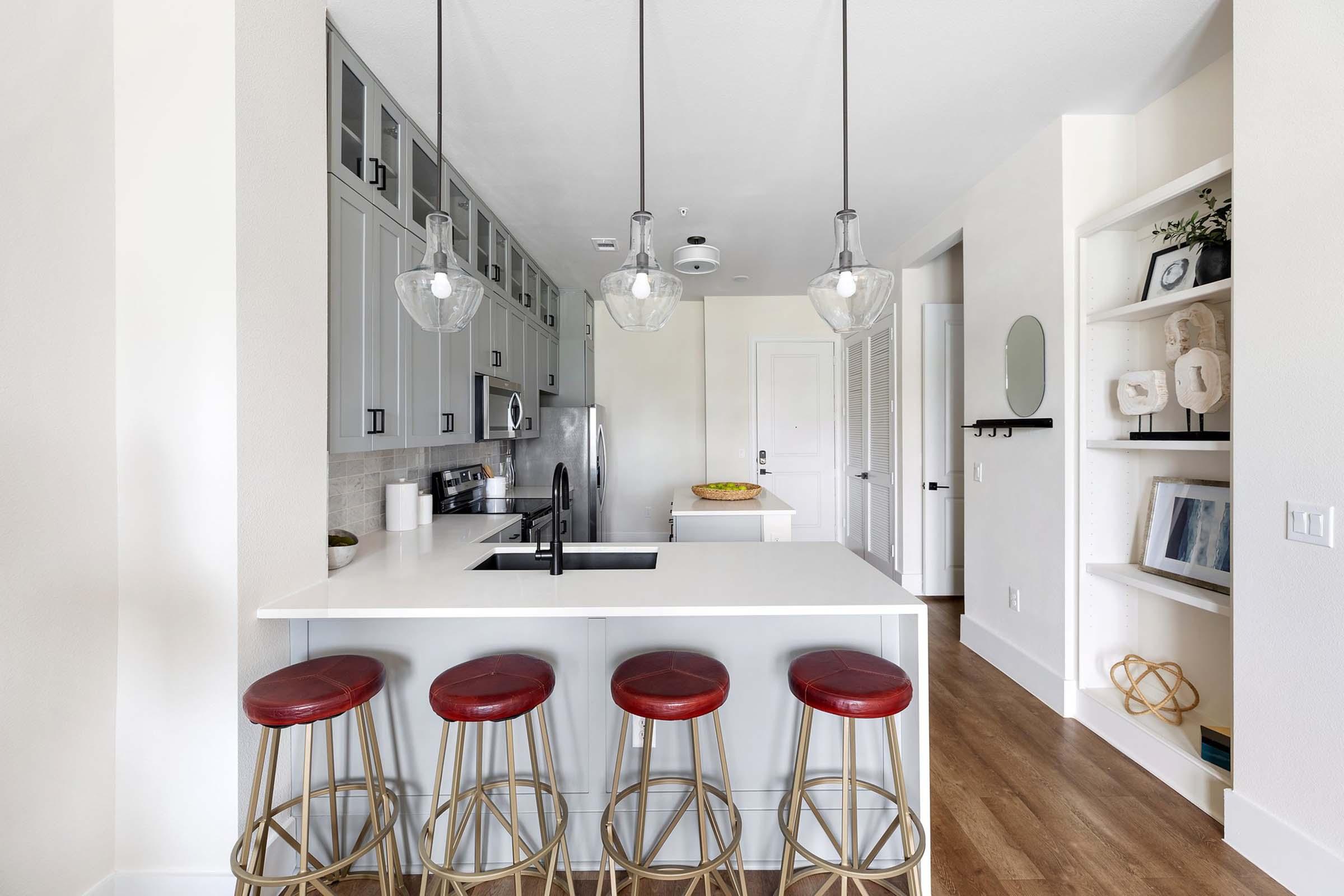 a kitchen with a sink and a mirror