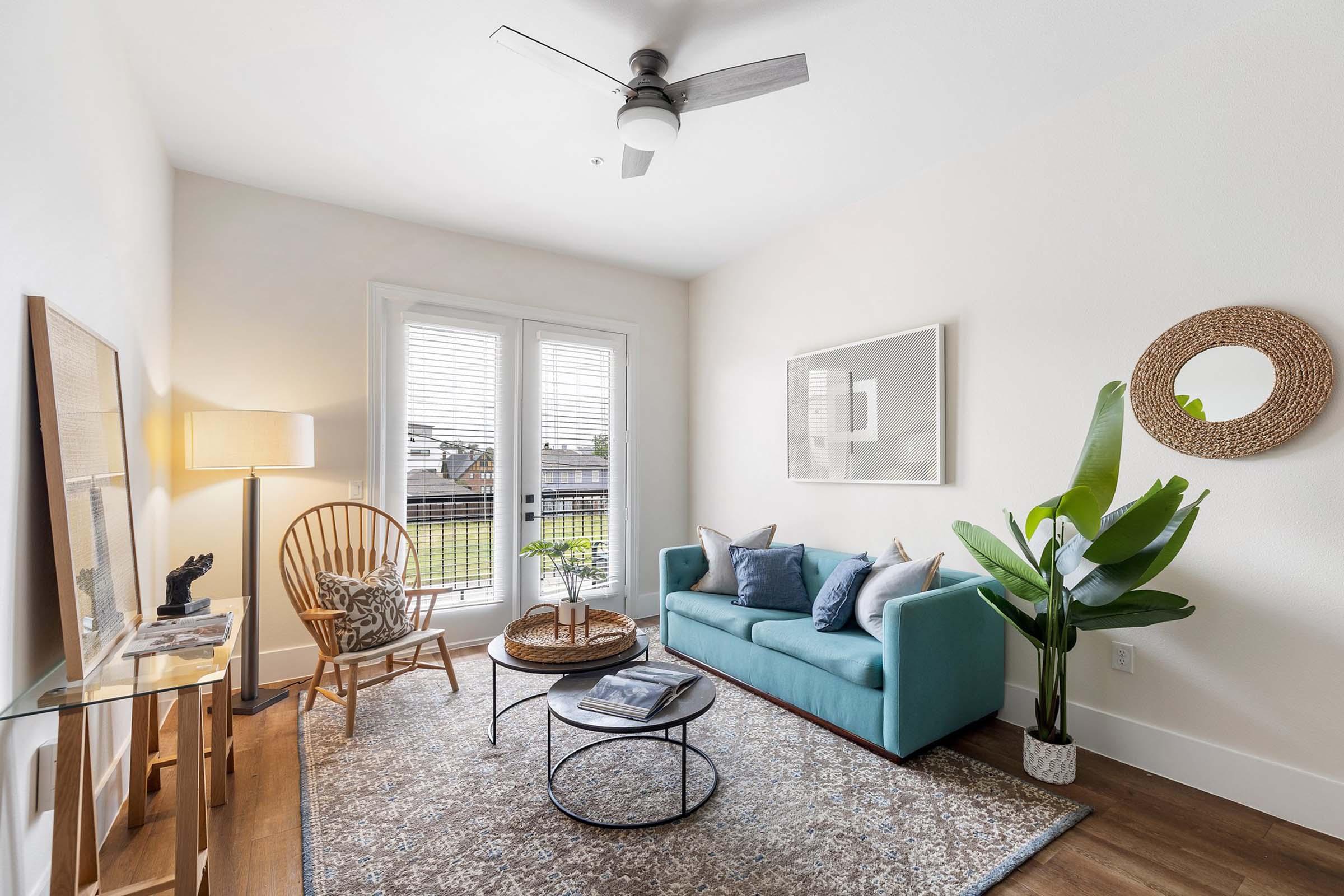 a living room filled with furniture and a window