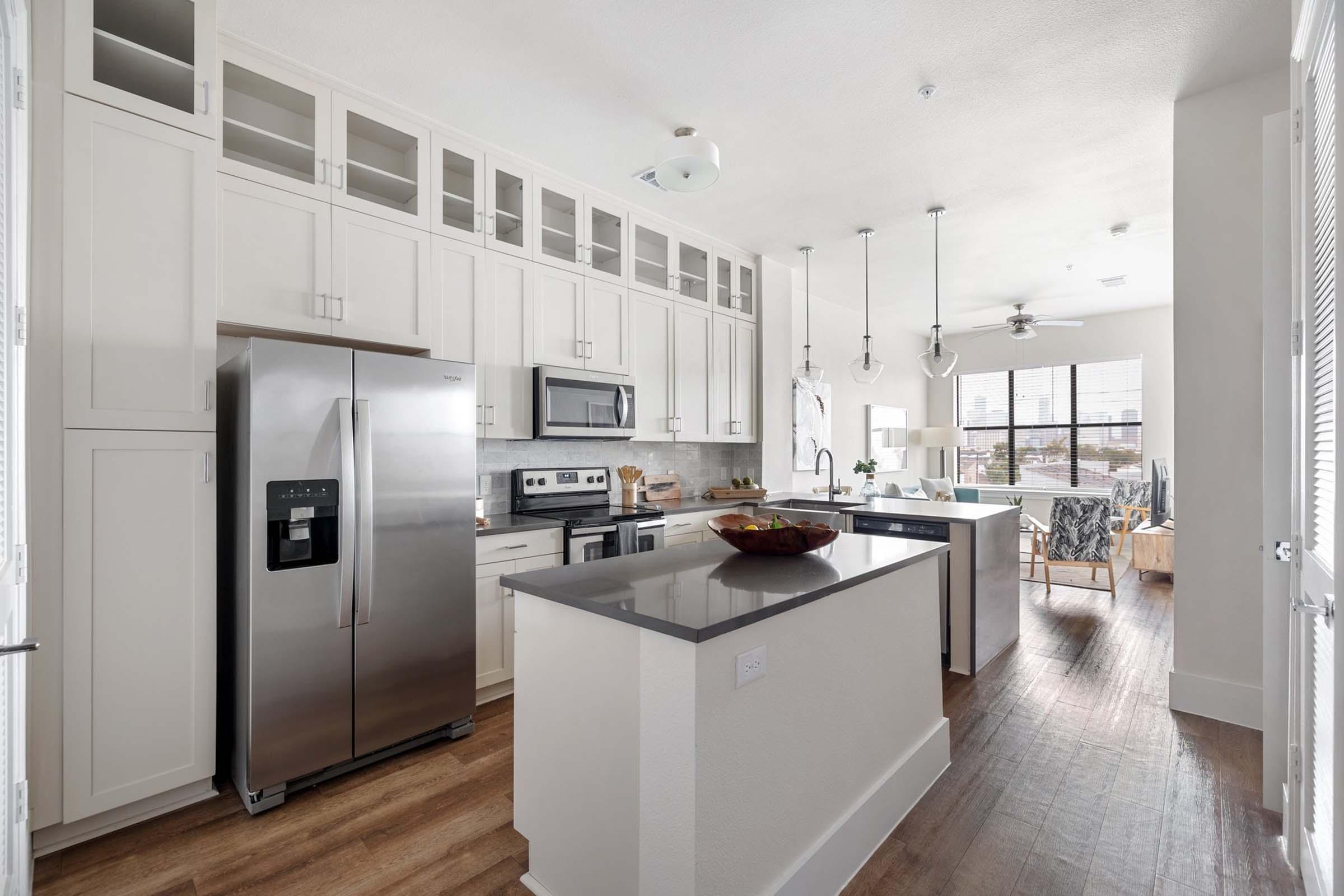 a kitchen with a sink and a refrigerator