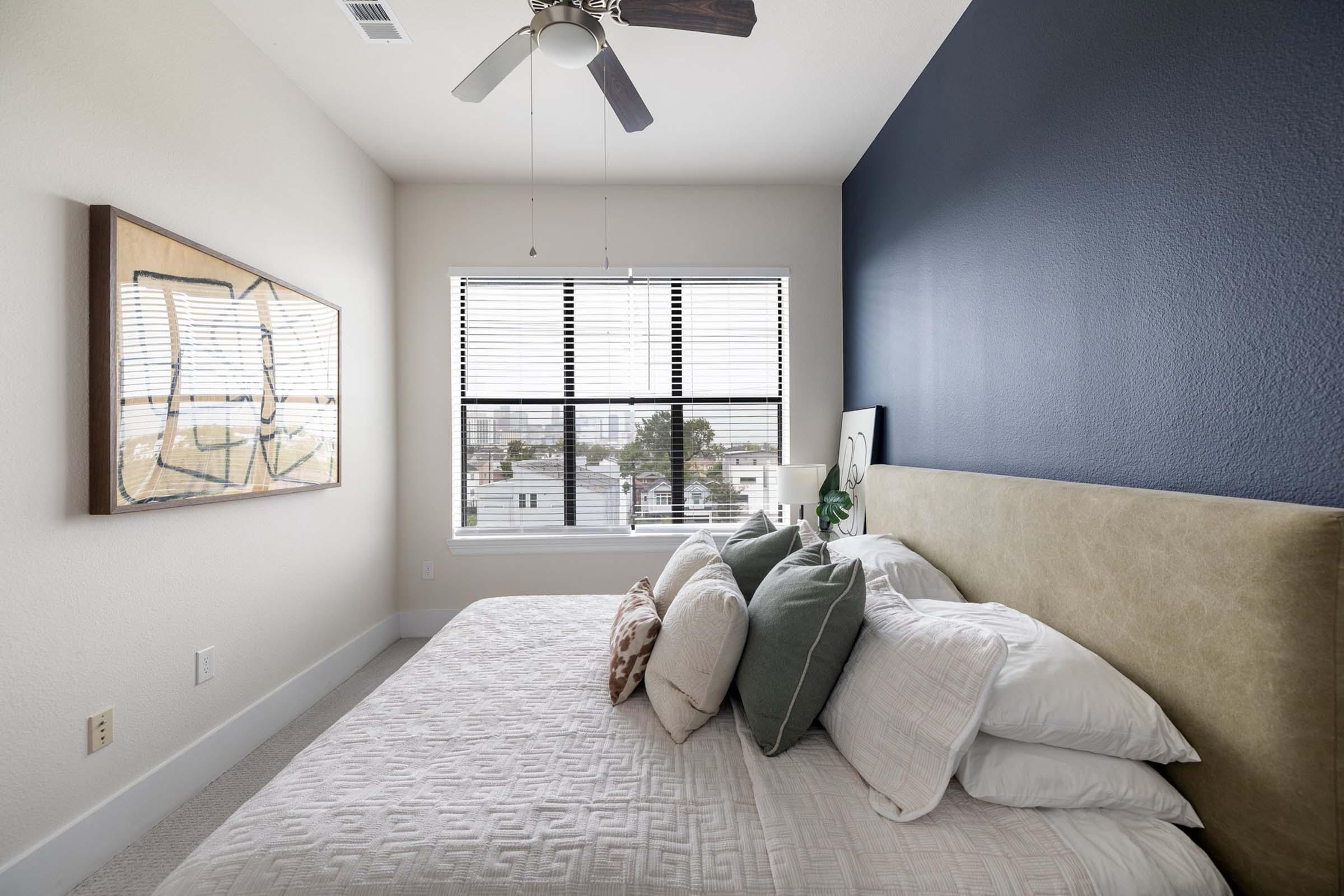 a view of a living room with a bed and a window