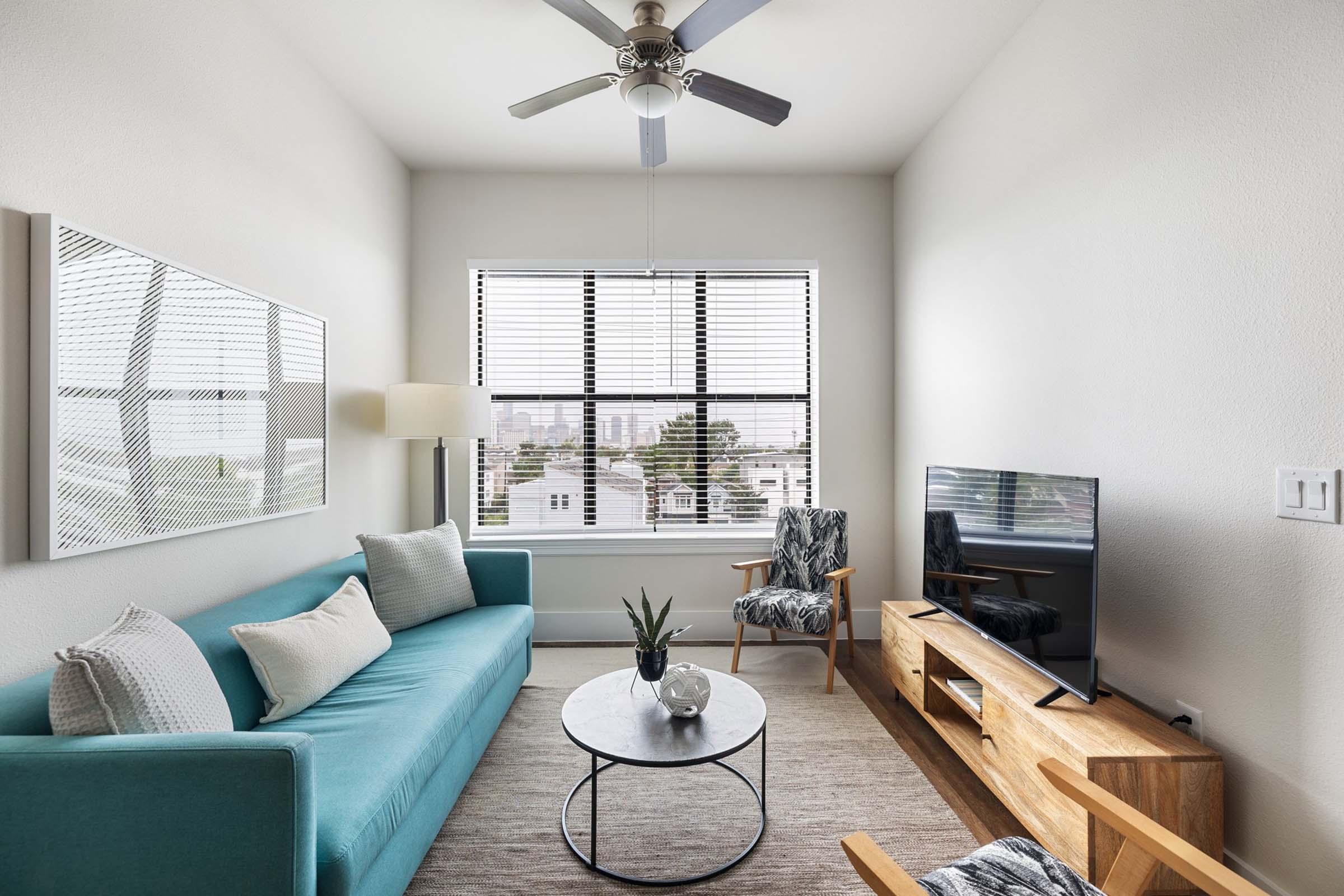 a living room filled with furniture and a large window