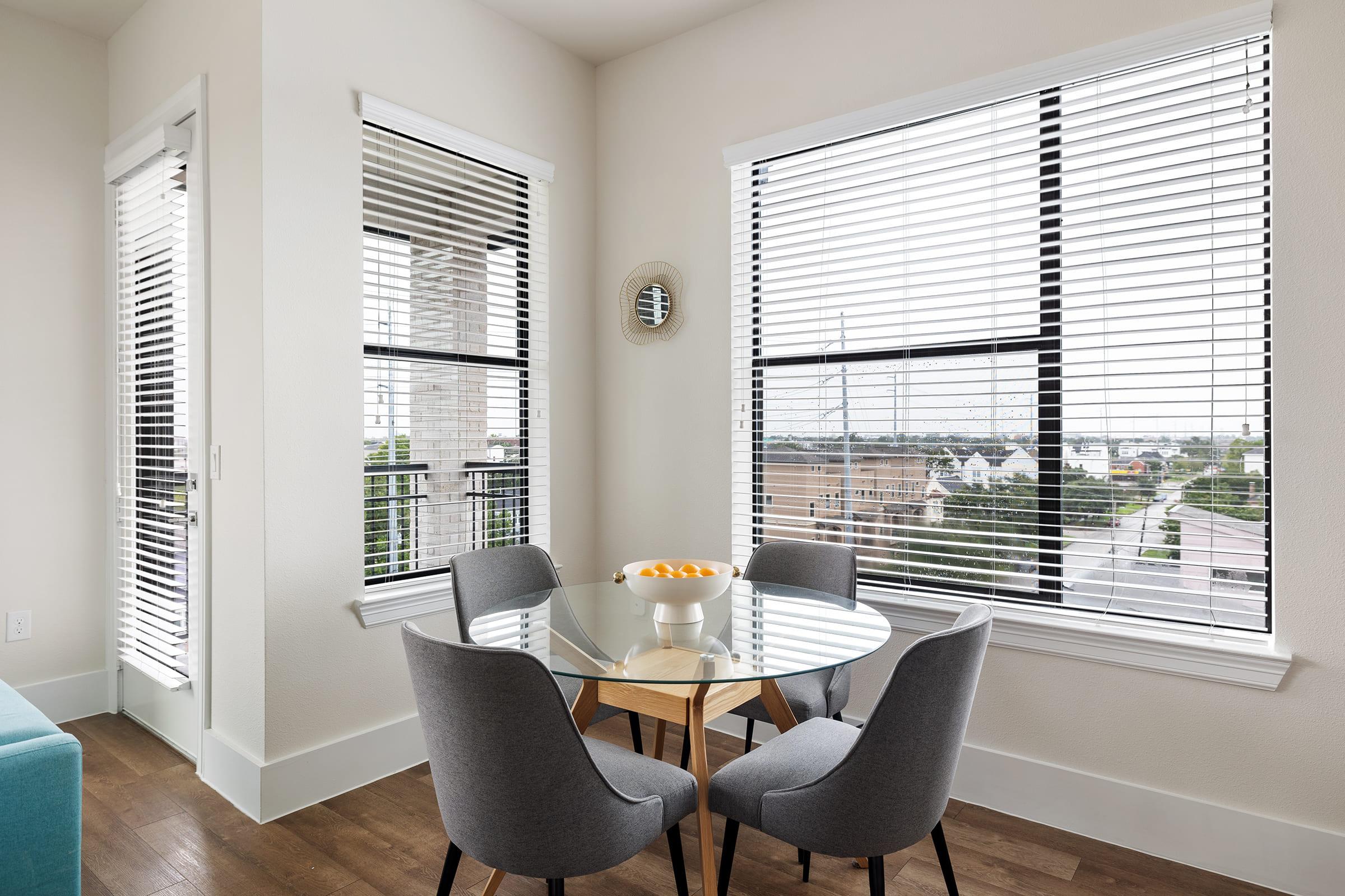 a living room filled with furniture and a large window