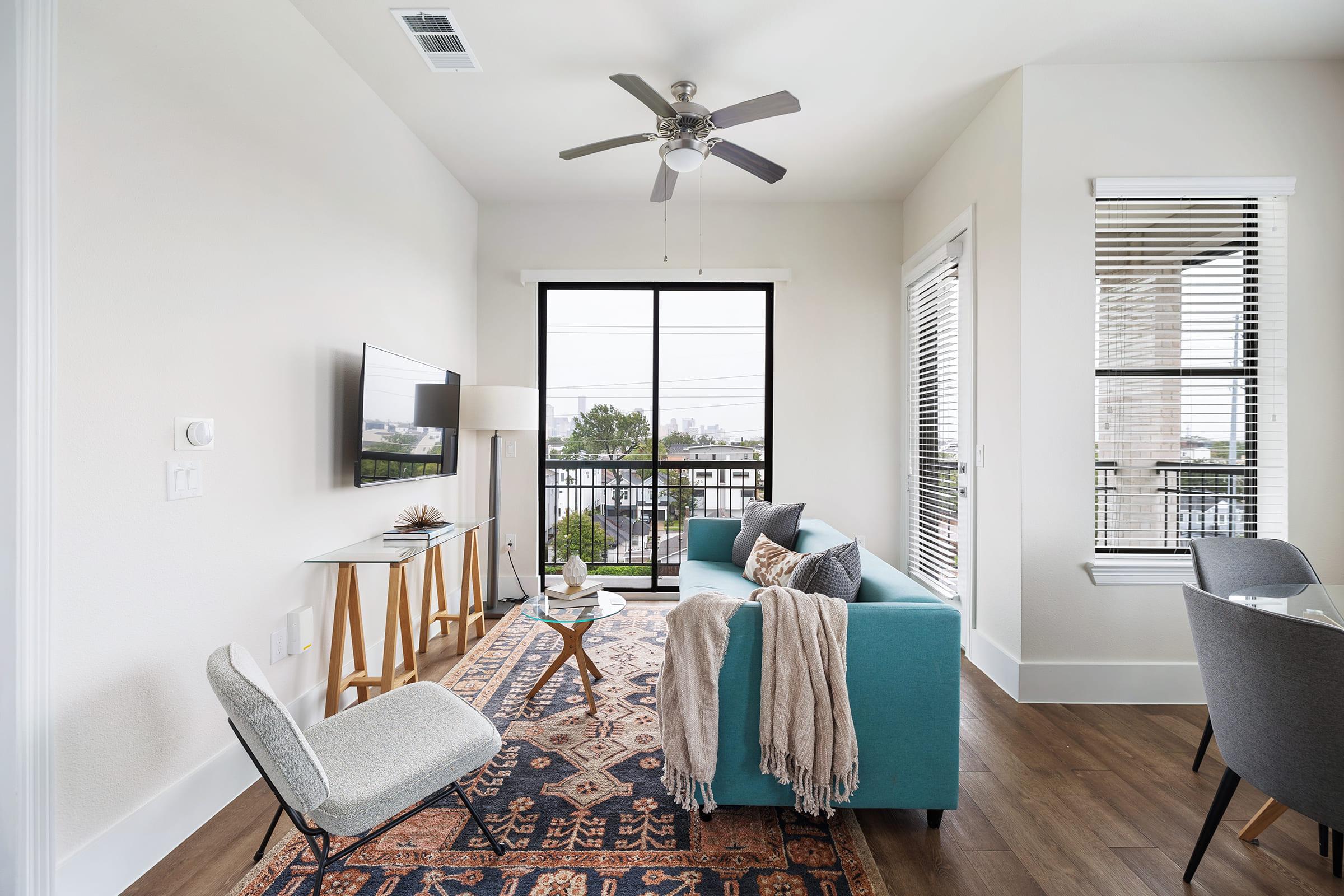 a living room filled with furniture and a large window