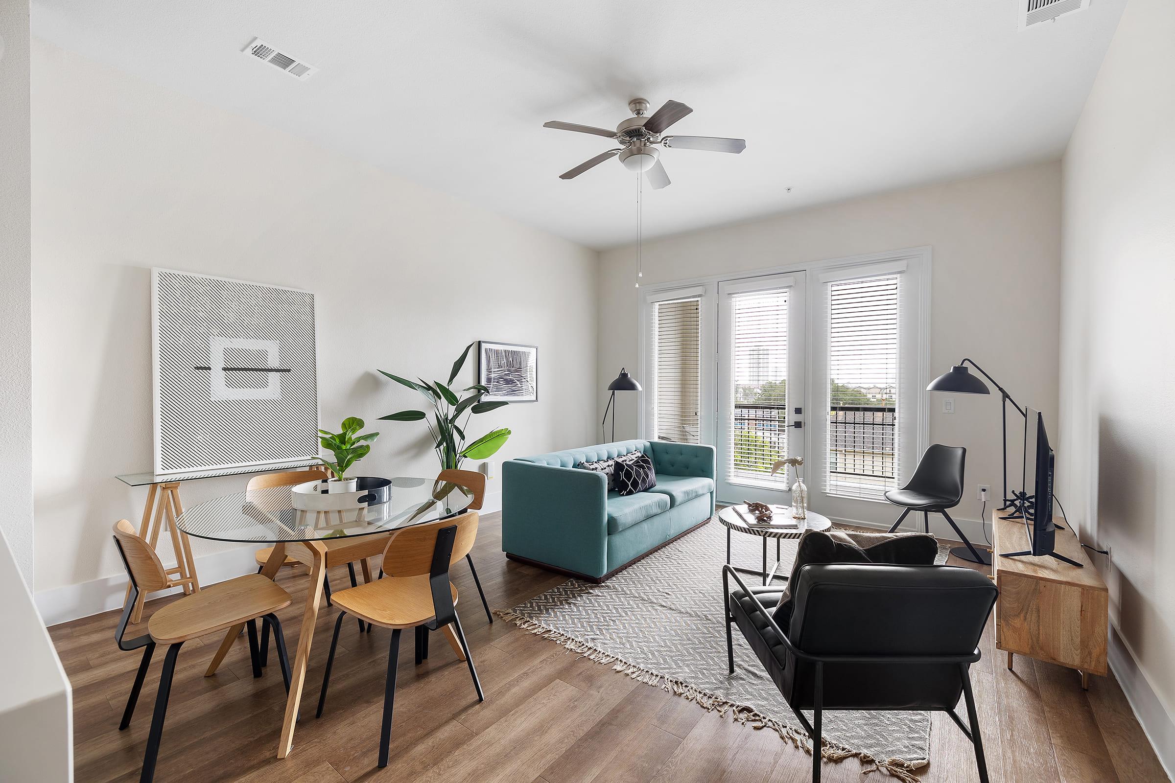 a living room filled with furniture and a large window