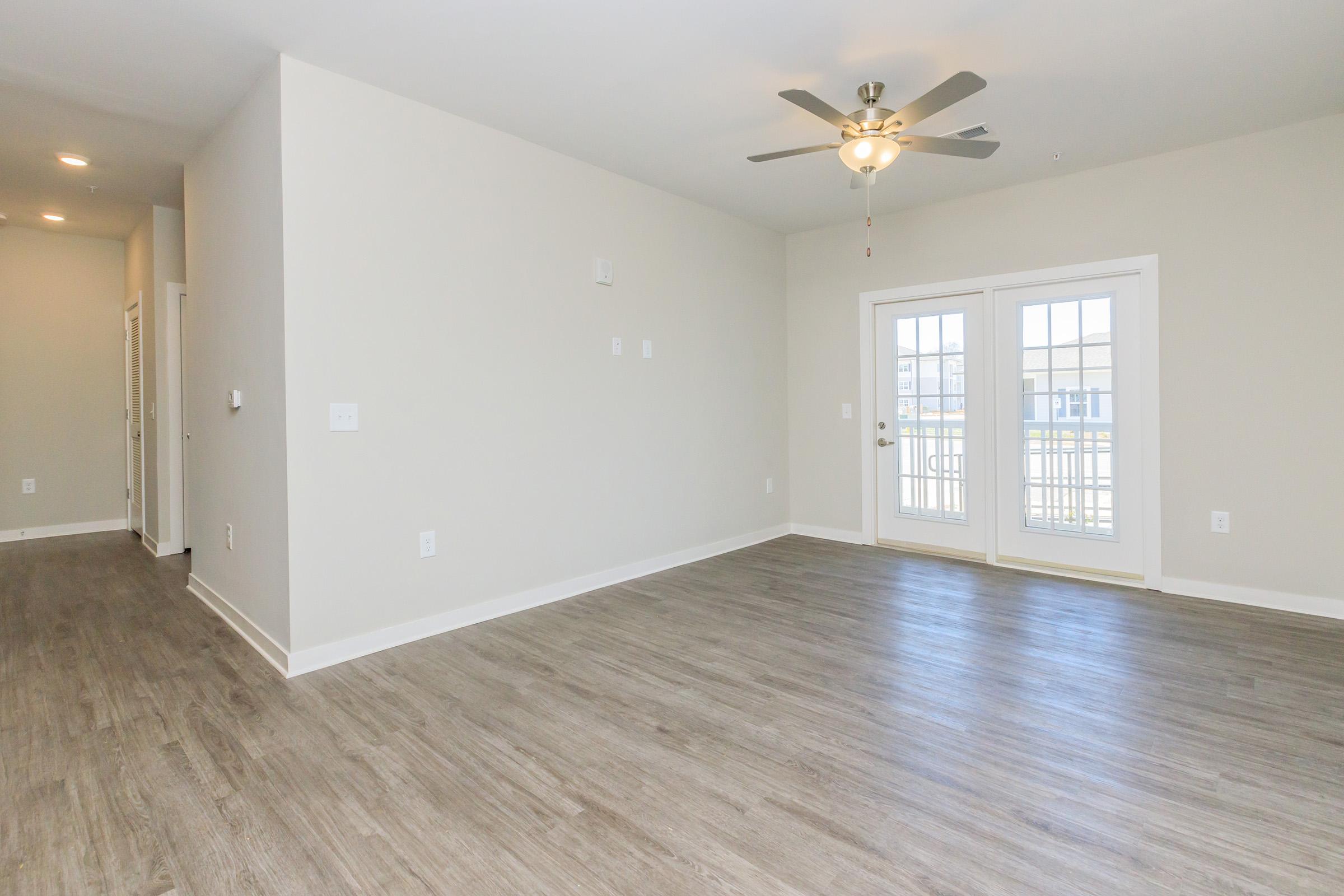 a large empty room with a wood floor