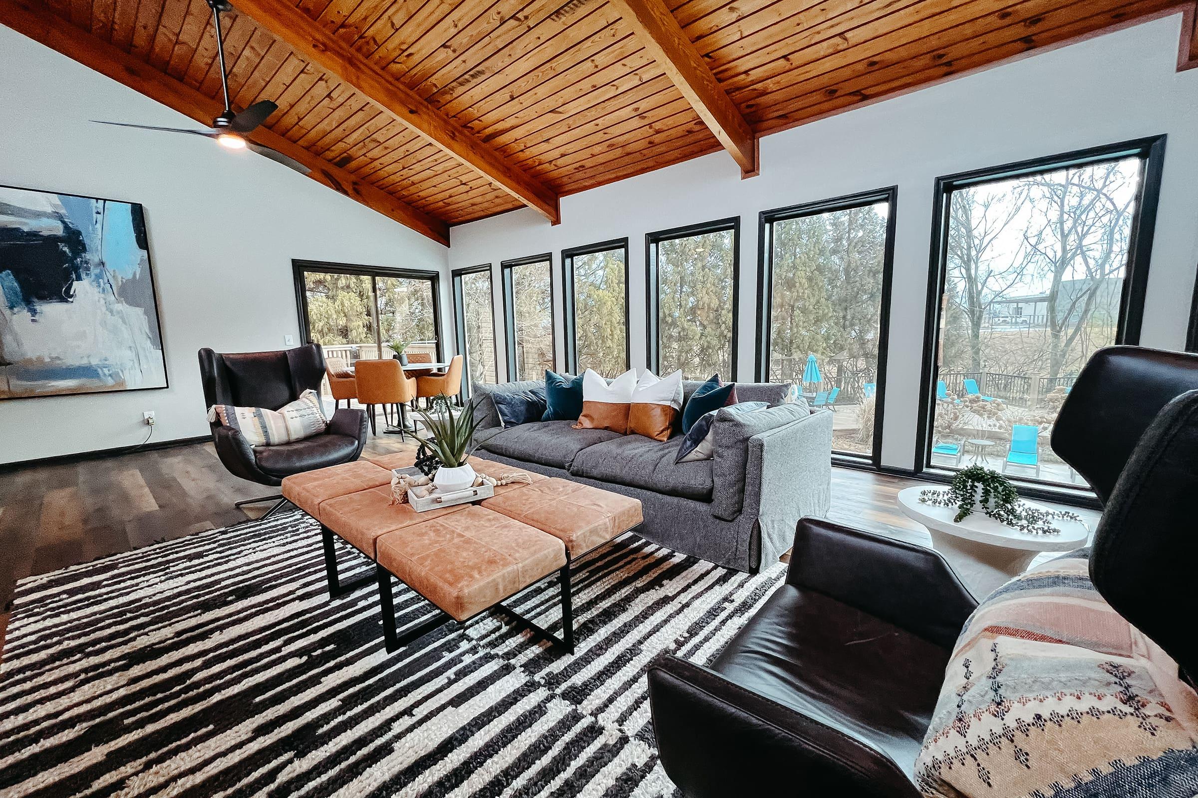 a living room filled with furniture and a large window