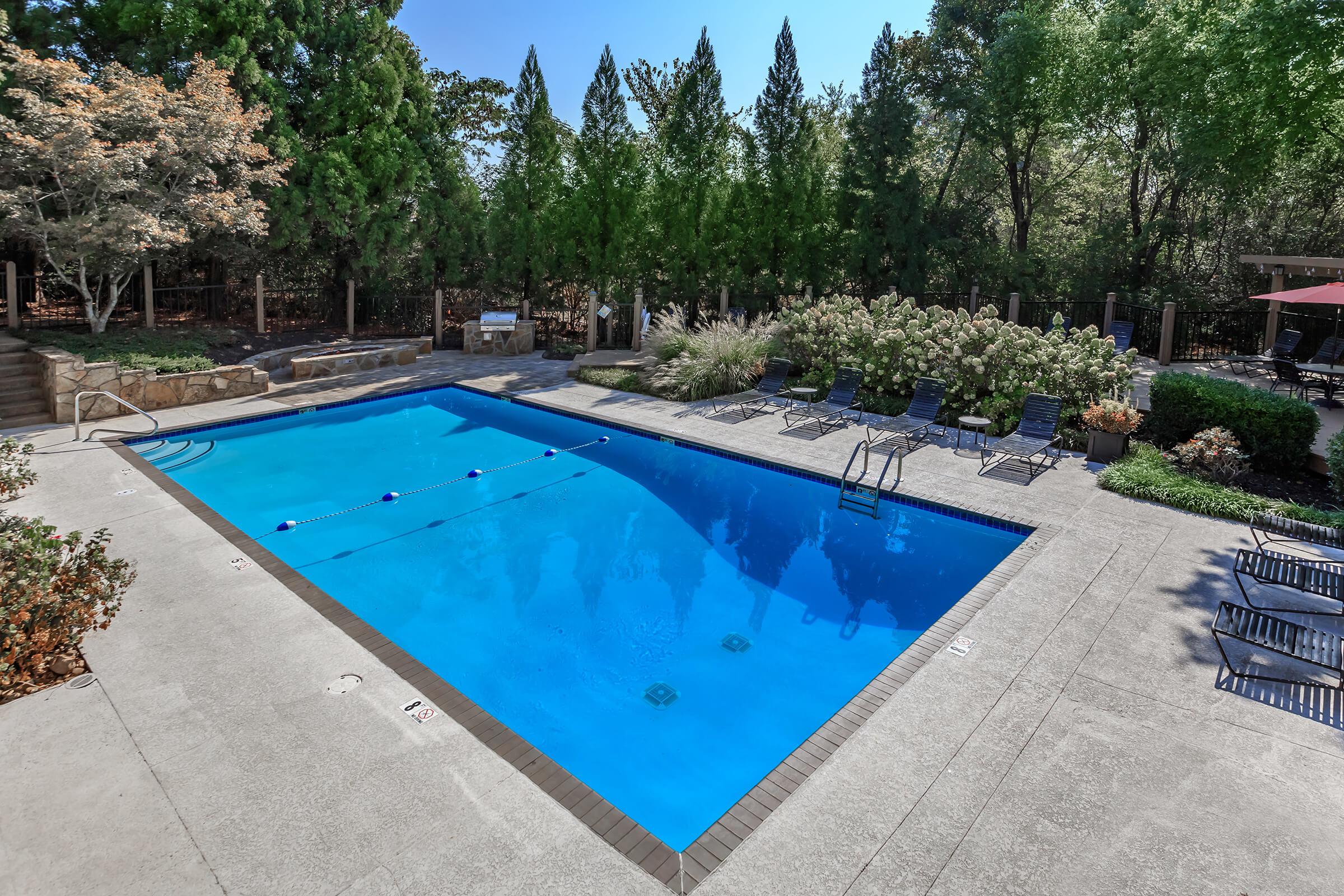 Swimming Pool Surrounded by Gorgeous Landscaping at Laurel Ridge Apartments in Chattanooga