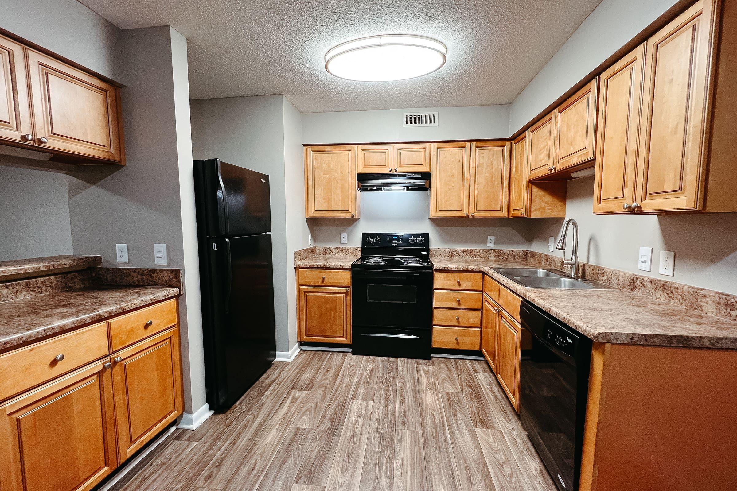 a modern kitchen with stainless steel appliances and wooden cabinets