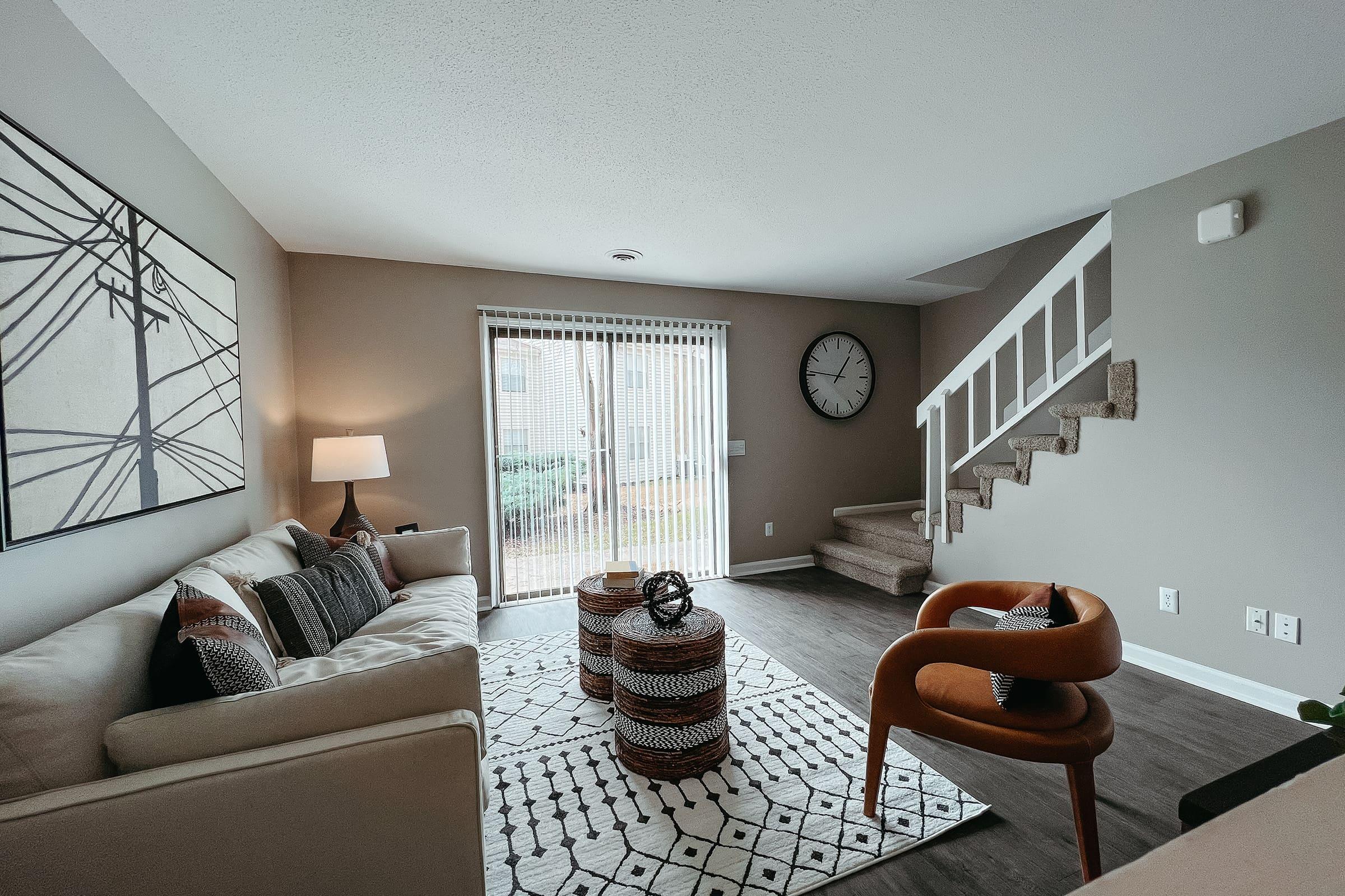 a living room filled with furniture and a large window