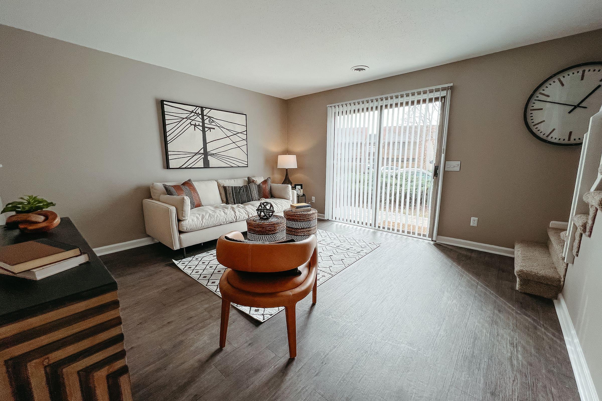 a living room filled with furniture and a rug