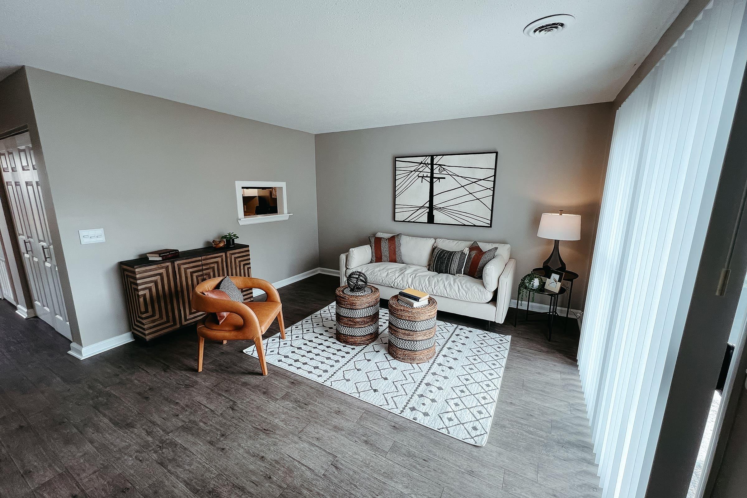 a living room filled with furniture and a rug