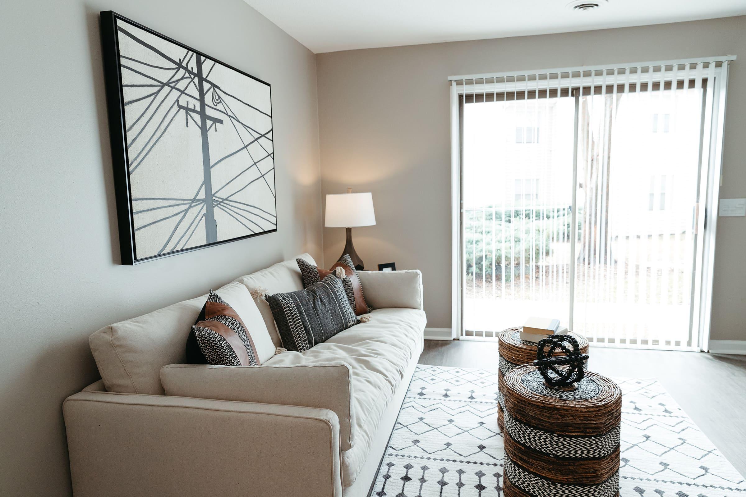 a living room filled with furniture and a large window