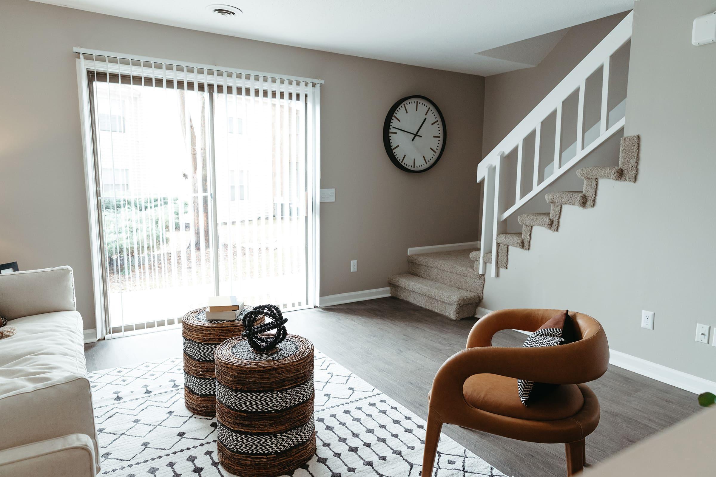 a bedroom with a clock on a table