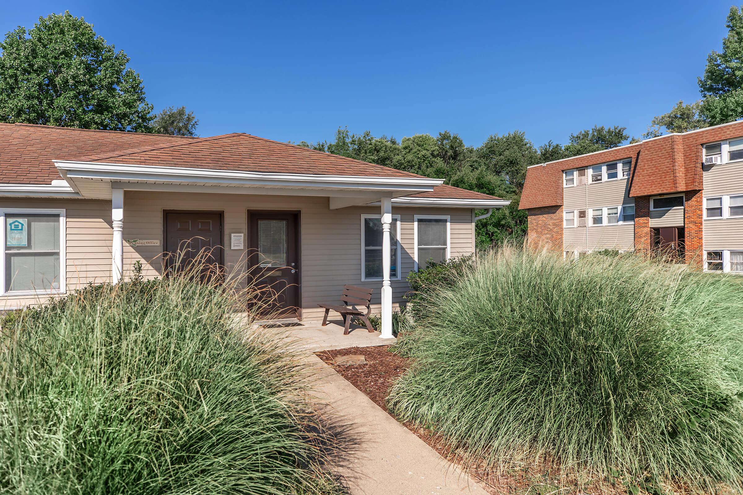 a house with bushes in front of a building