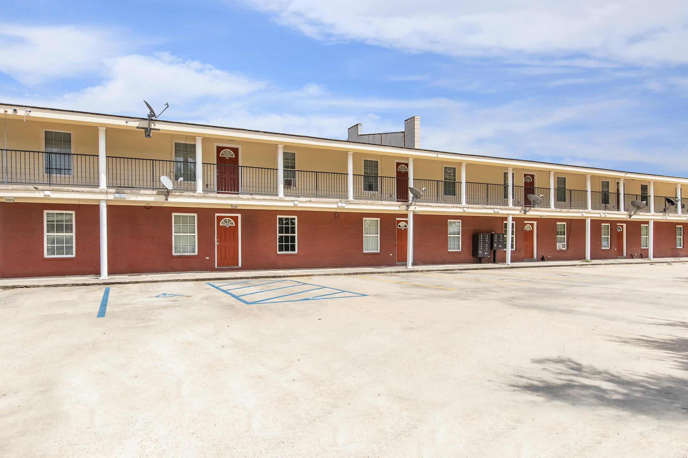 a group of people on a beach in front of a building