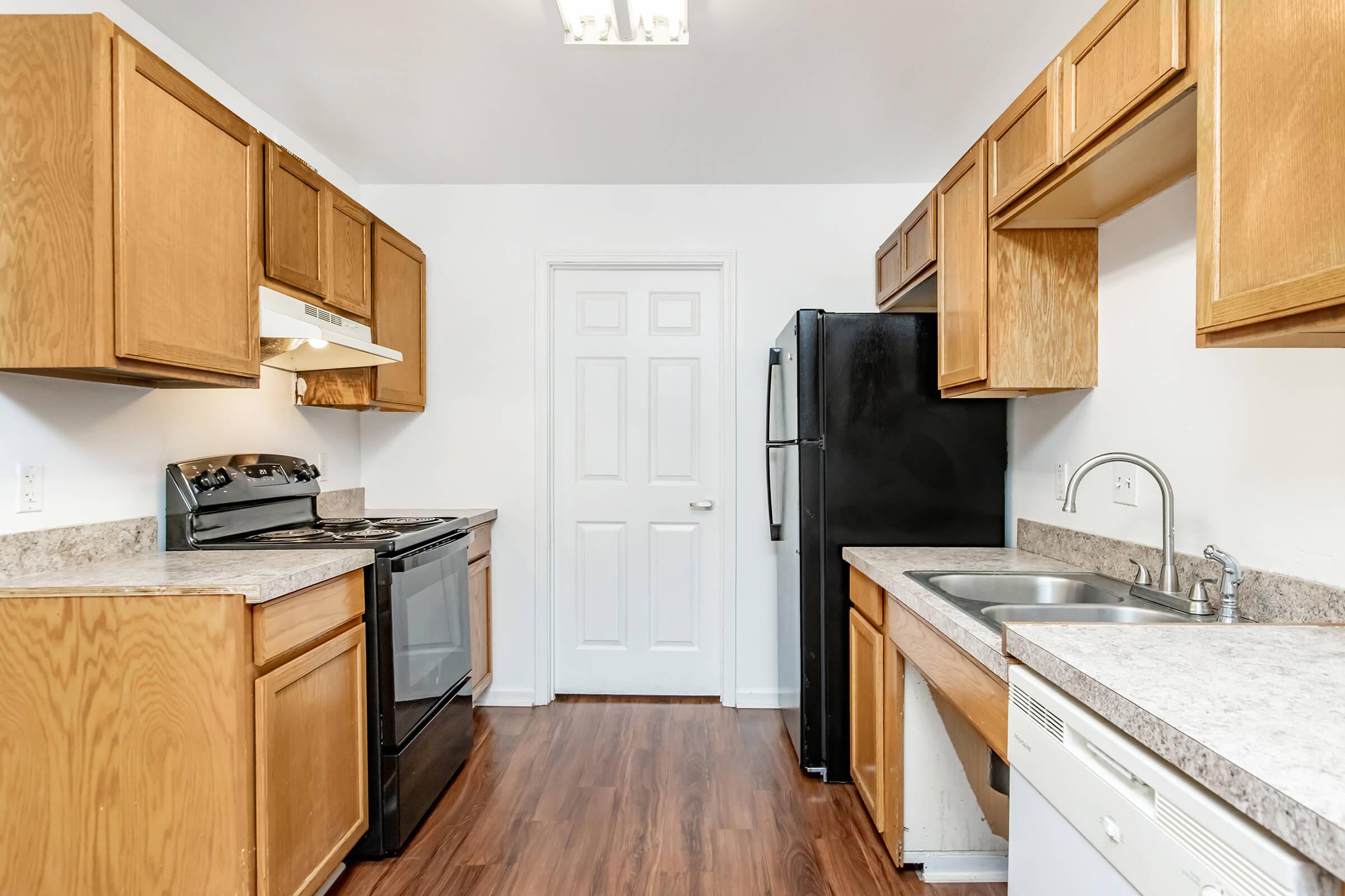 a kitchen with stainless steel appliances and wooden cabinets