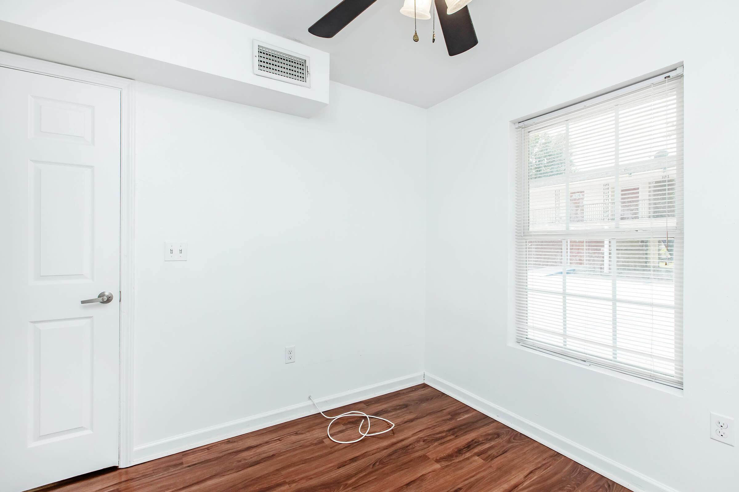 a kitchen with wooden cabinets and a window