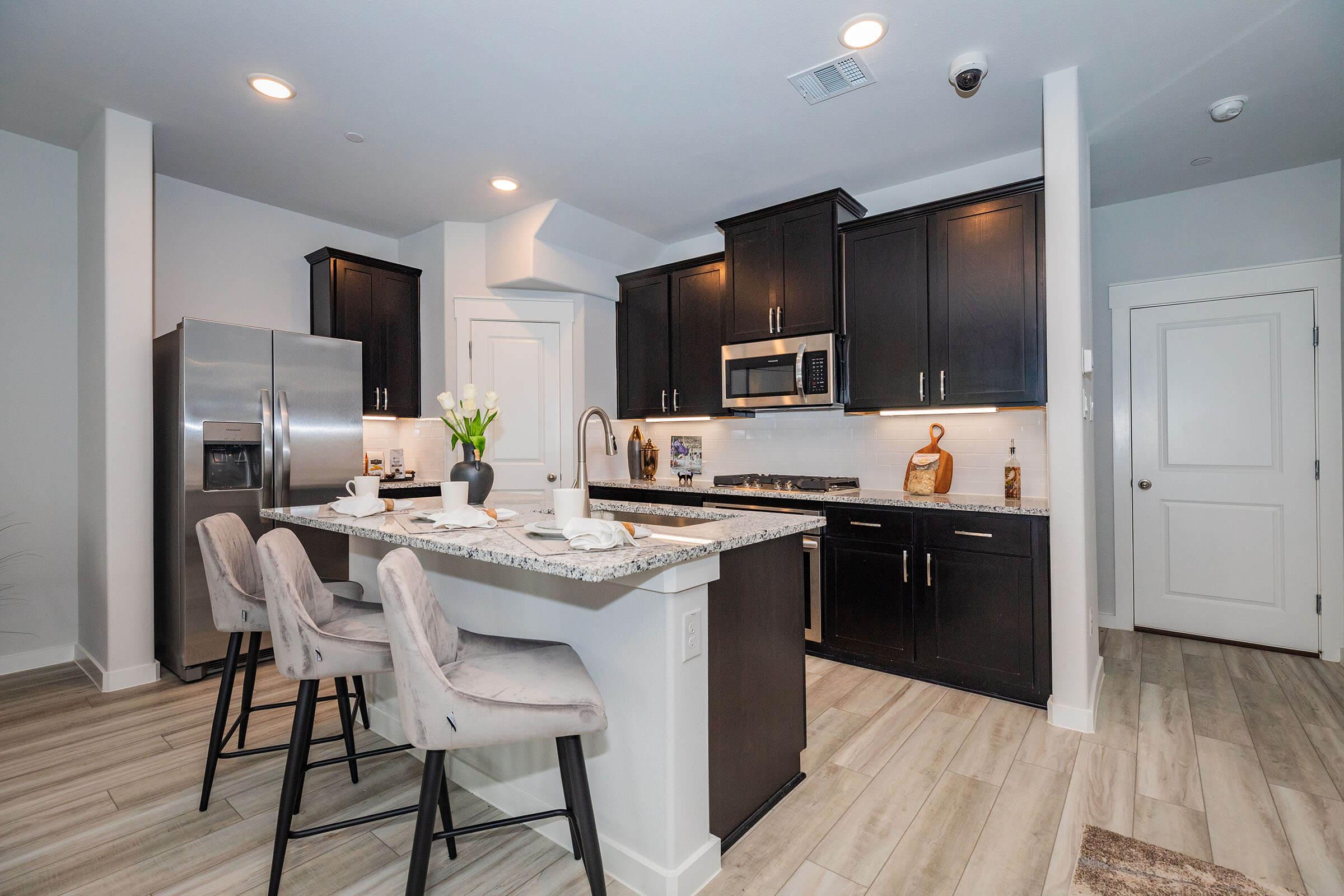 a modern kitchen with an island in the middle of a room