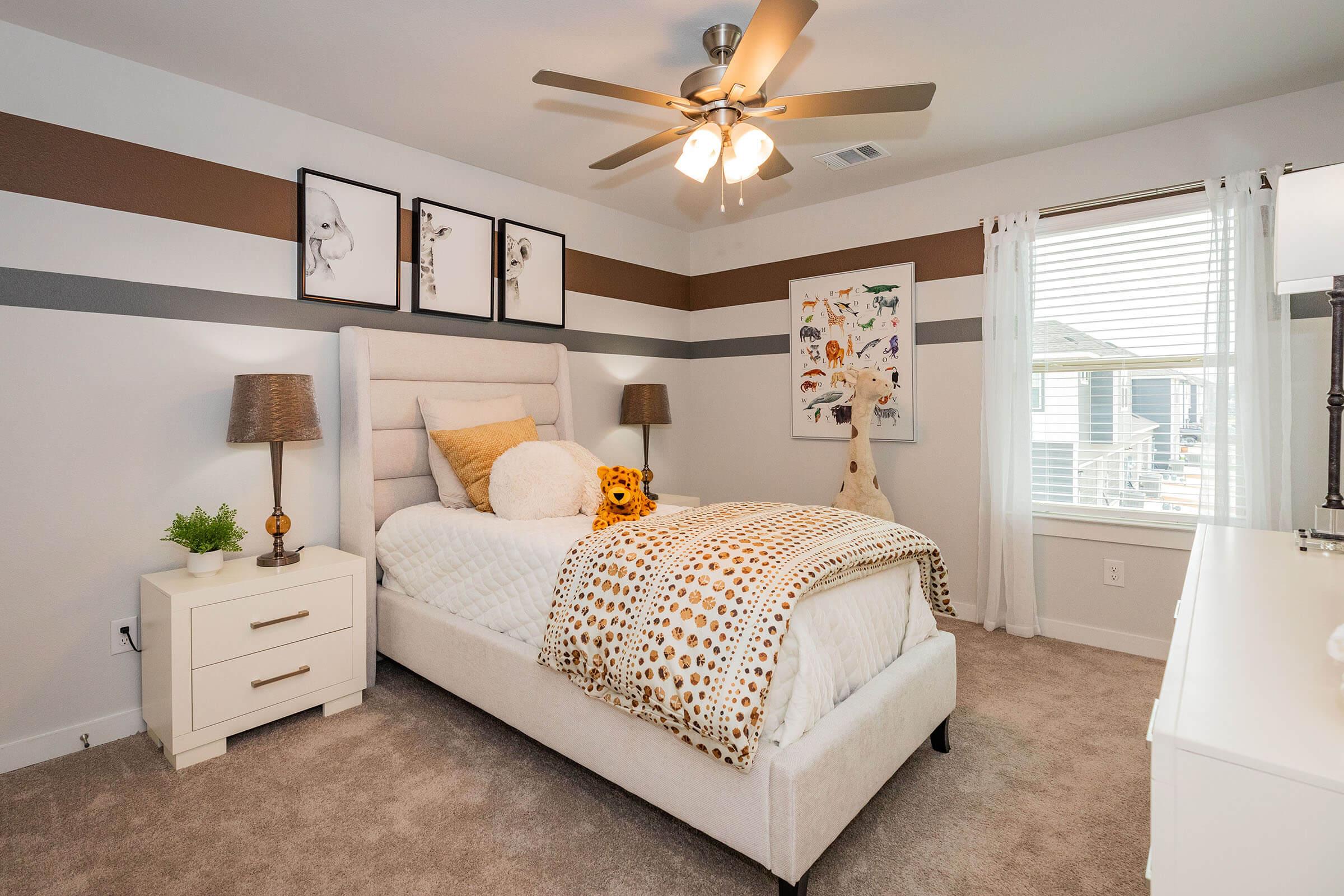 a bedroom with a bed and desk in a room