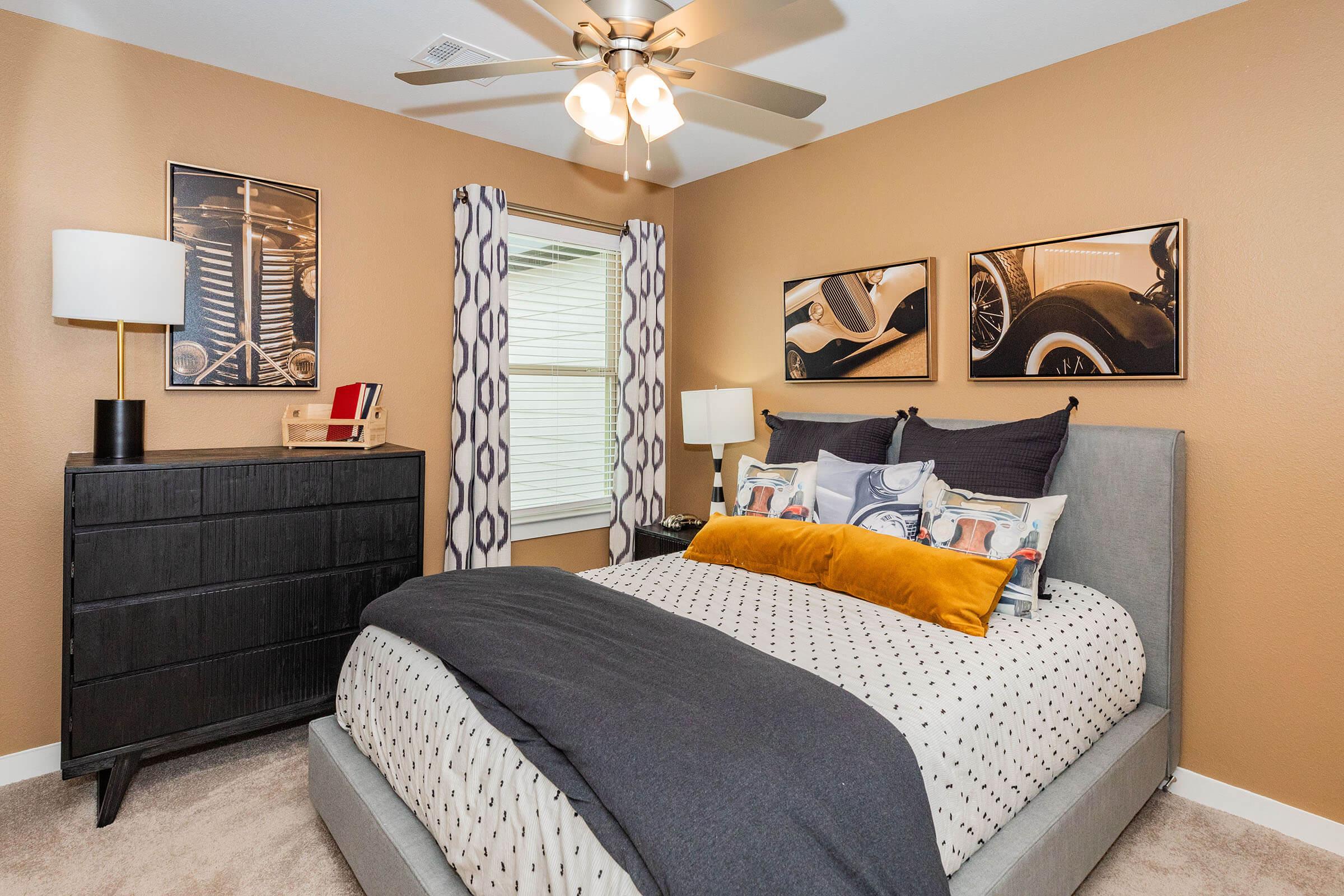 a bedroom with a bed and desk in a room