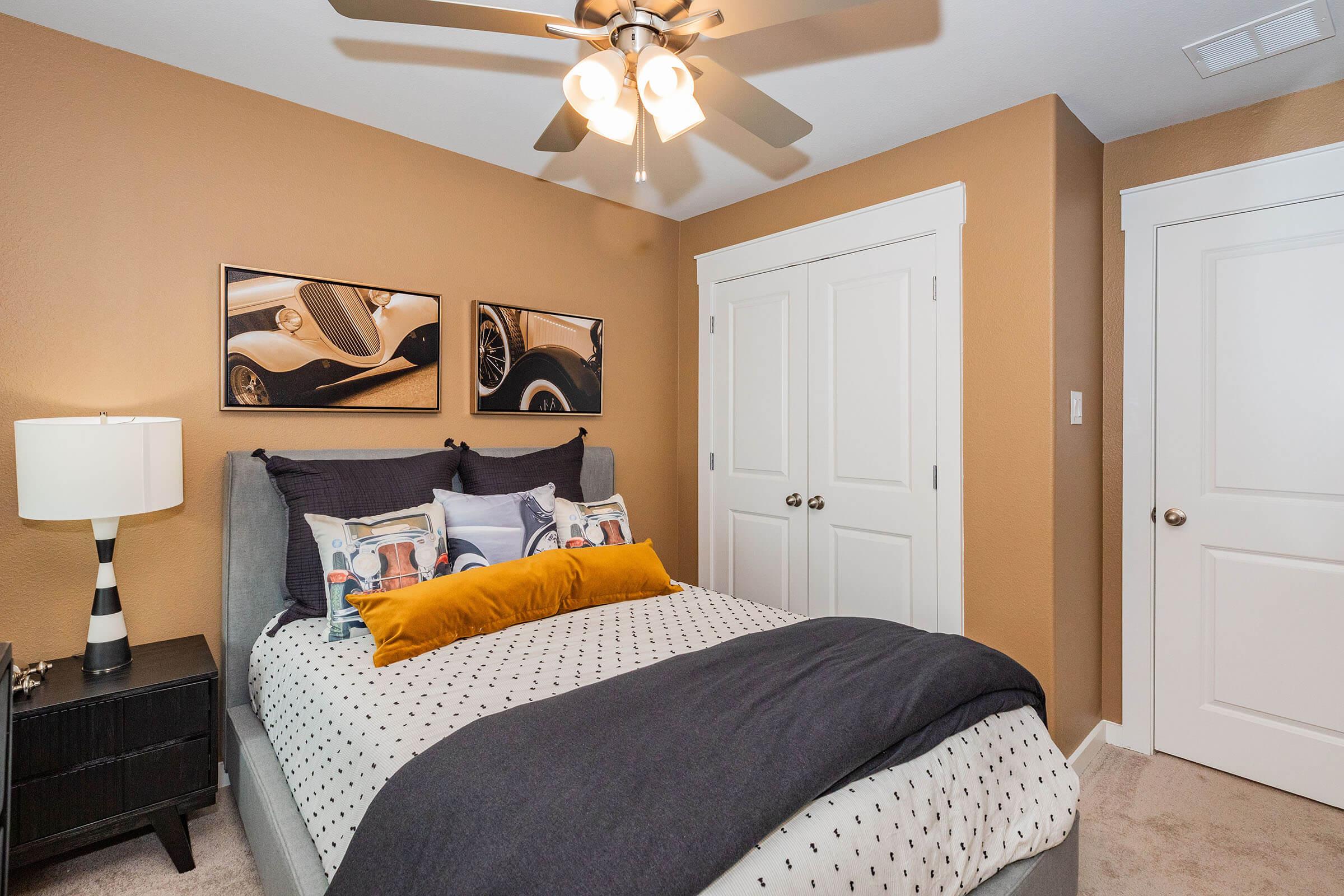 a bedroom with a bed and desk in a room