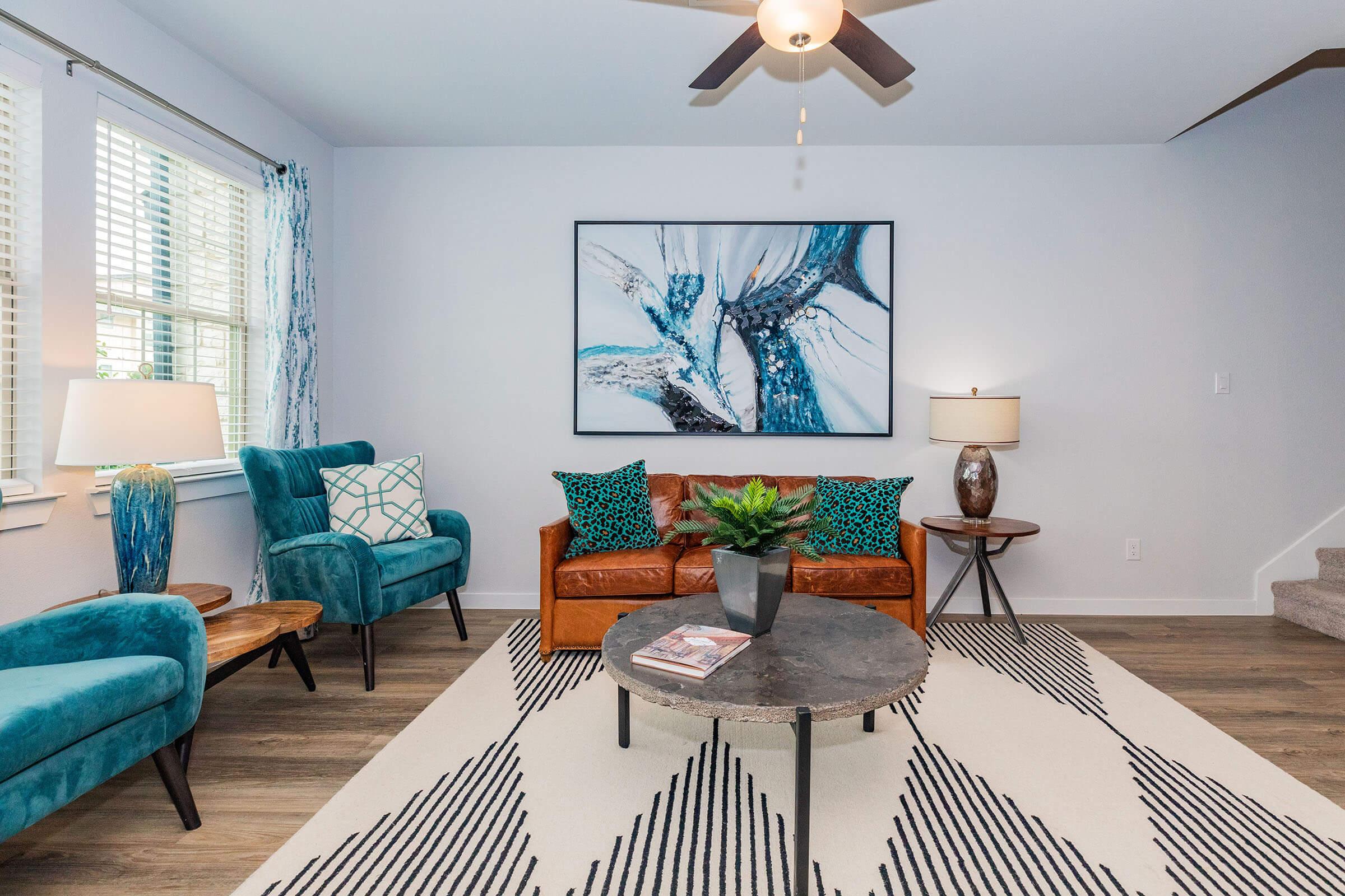 a living room filled with furniture and a large window