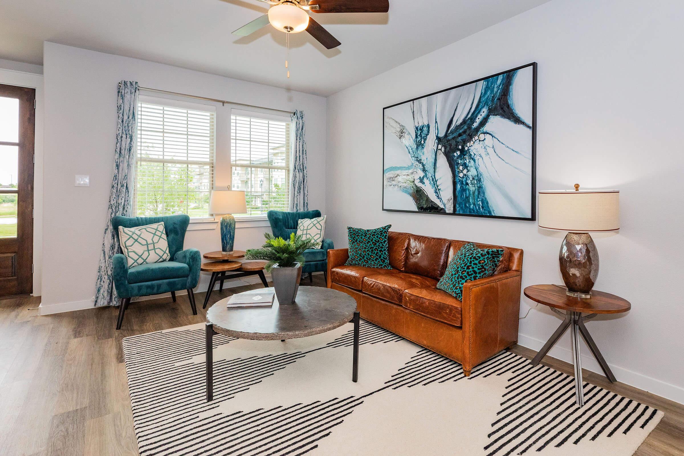 a living room filled with furniture and a large window