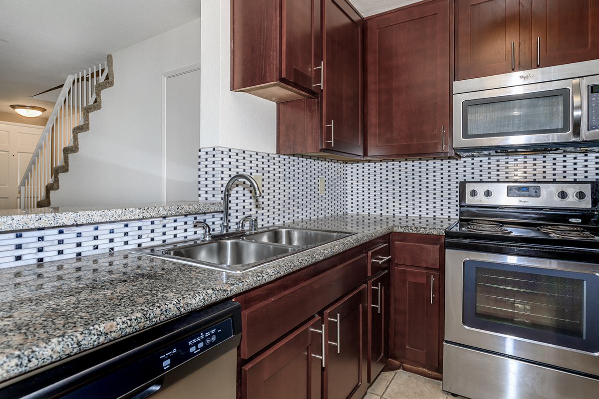 a kitchen with stainless steel appliances and wooden cabinets