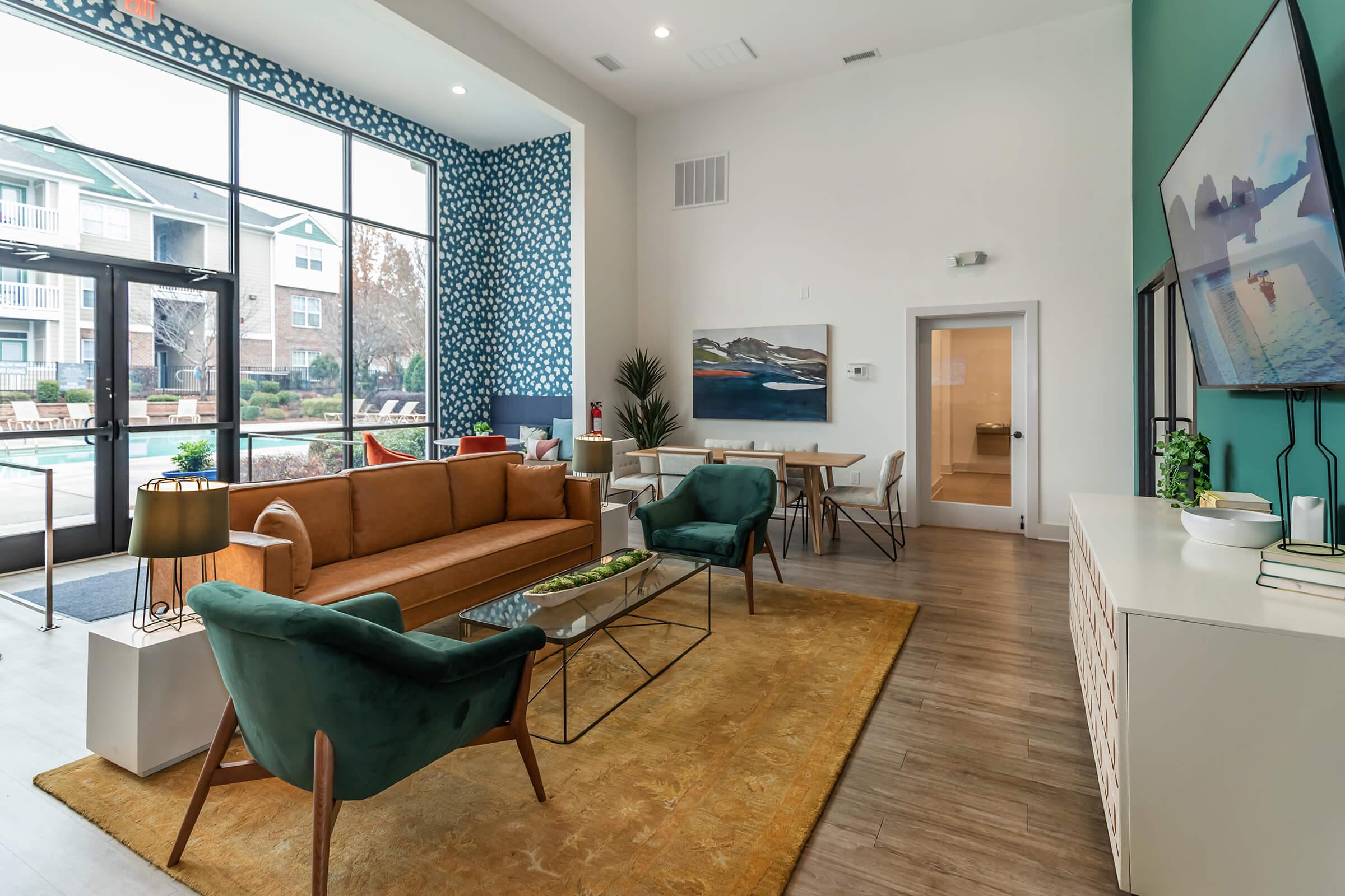 a living room filled with furniture and a large window