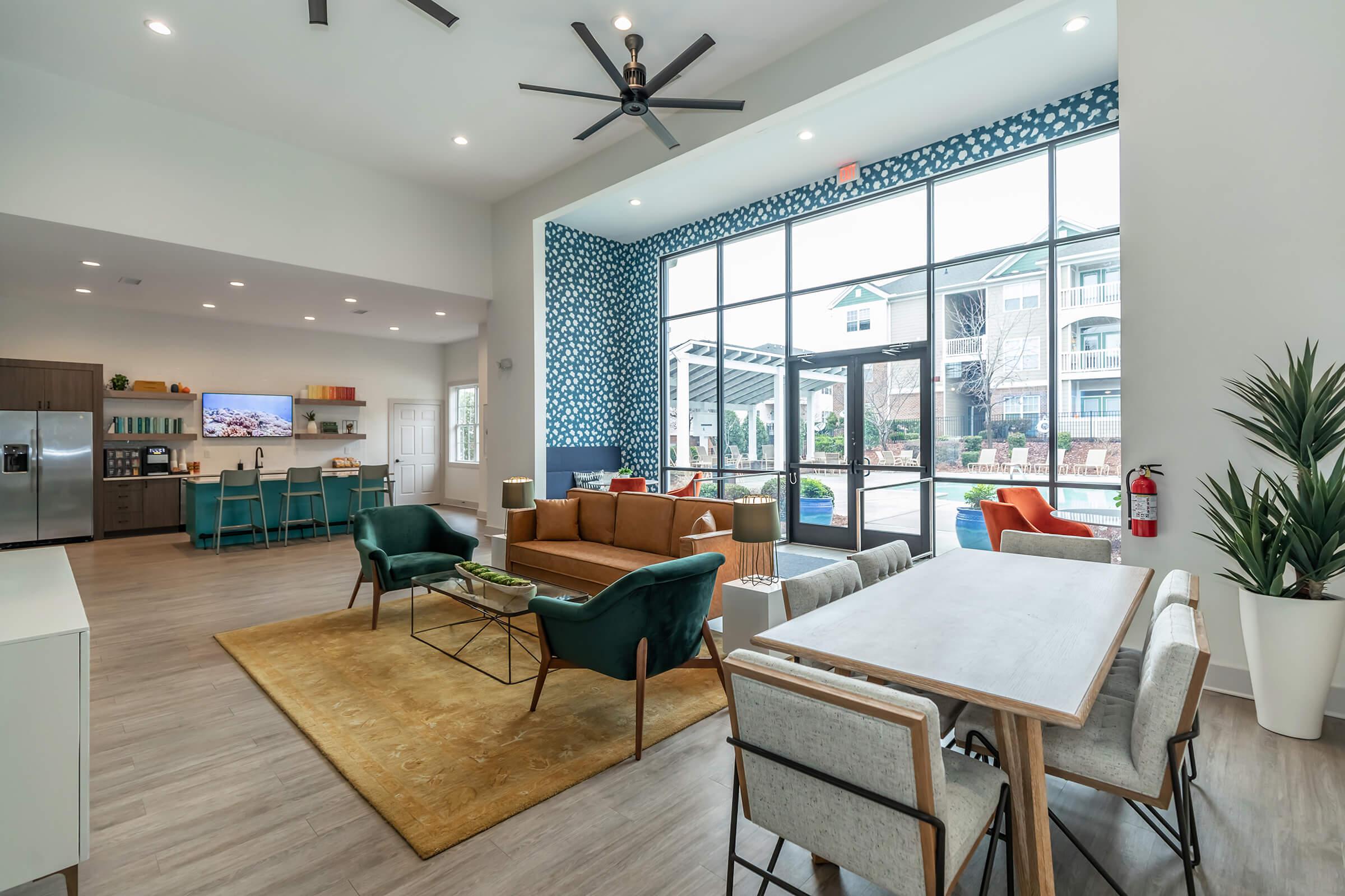 a living room filled with furniture and a large window