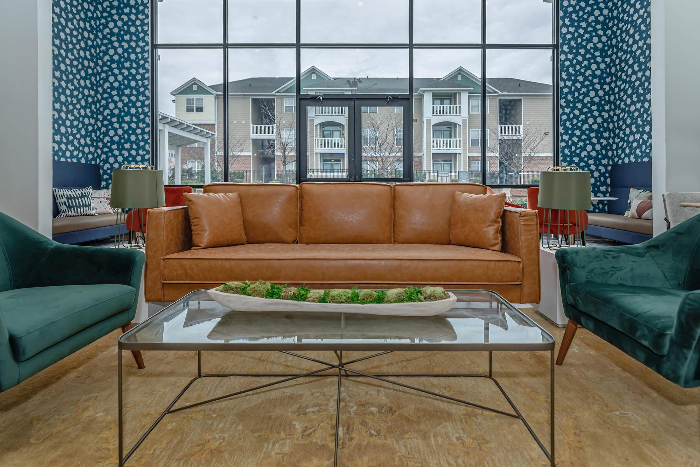 a living room filled with furniture and a large window